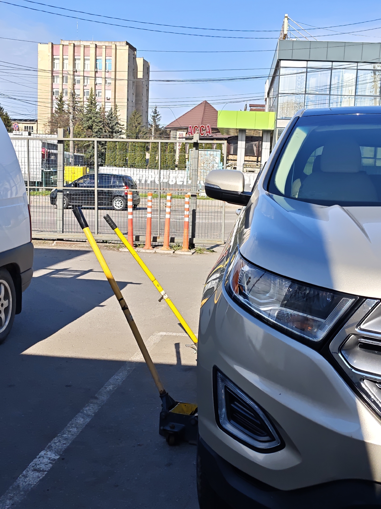 Driver changes tire in Vinnytsia parking lot early morning