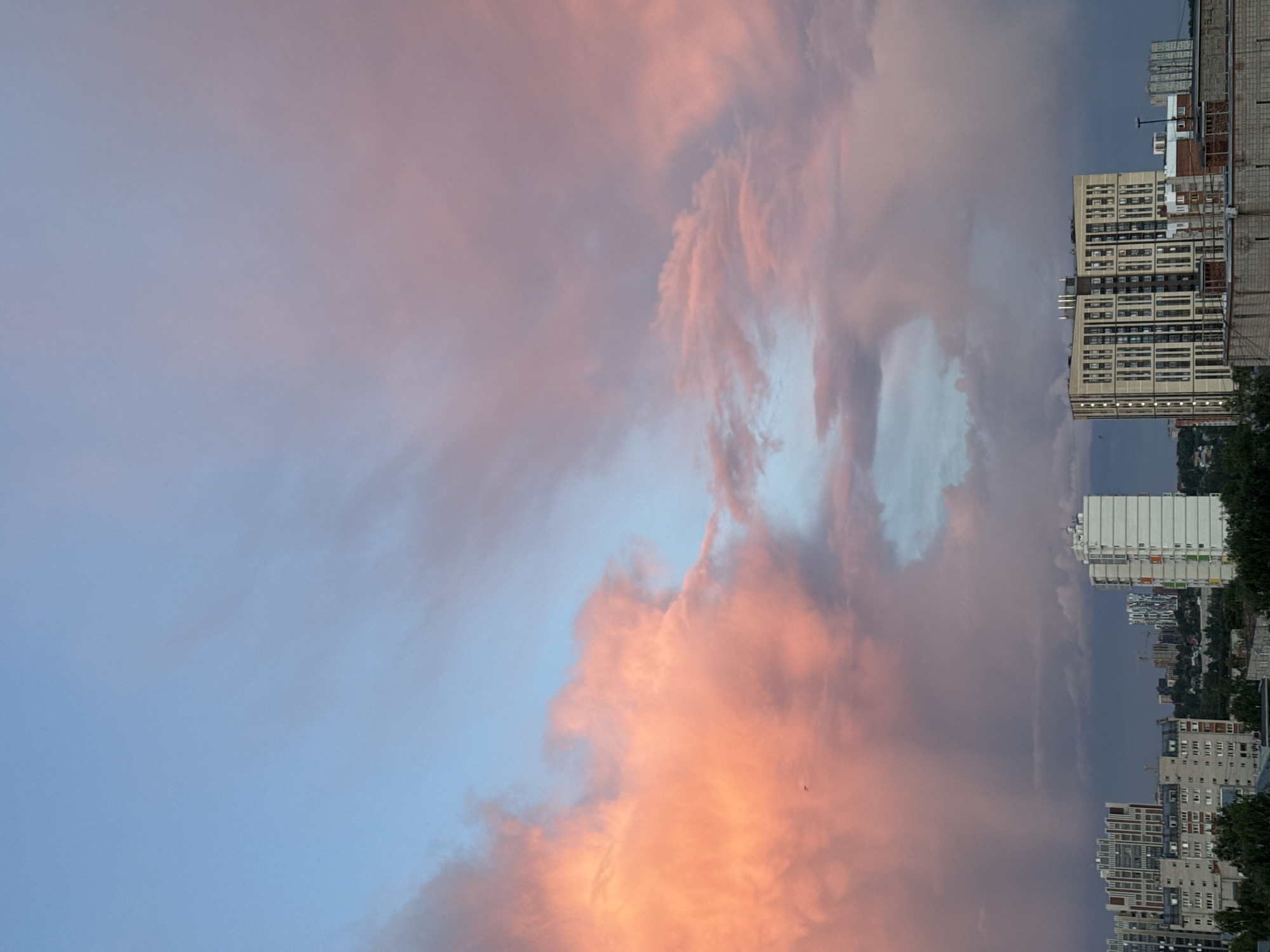 Sunset observed over Izhevsk cityscape with colorful clouds