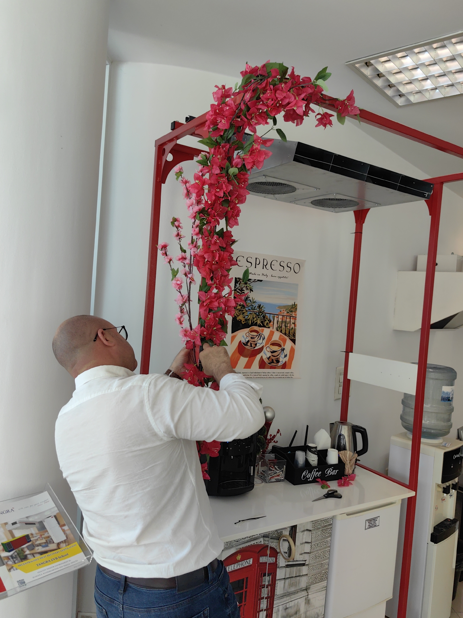 Man arranges flowers near Sofia furniture store entrance