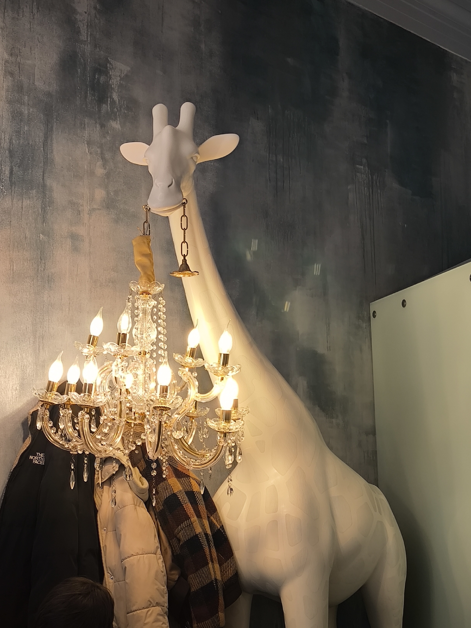 Moscow cafe features large white giraffe statue decoration
