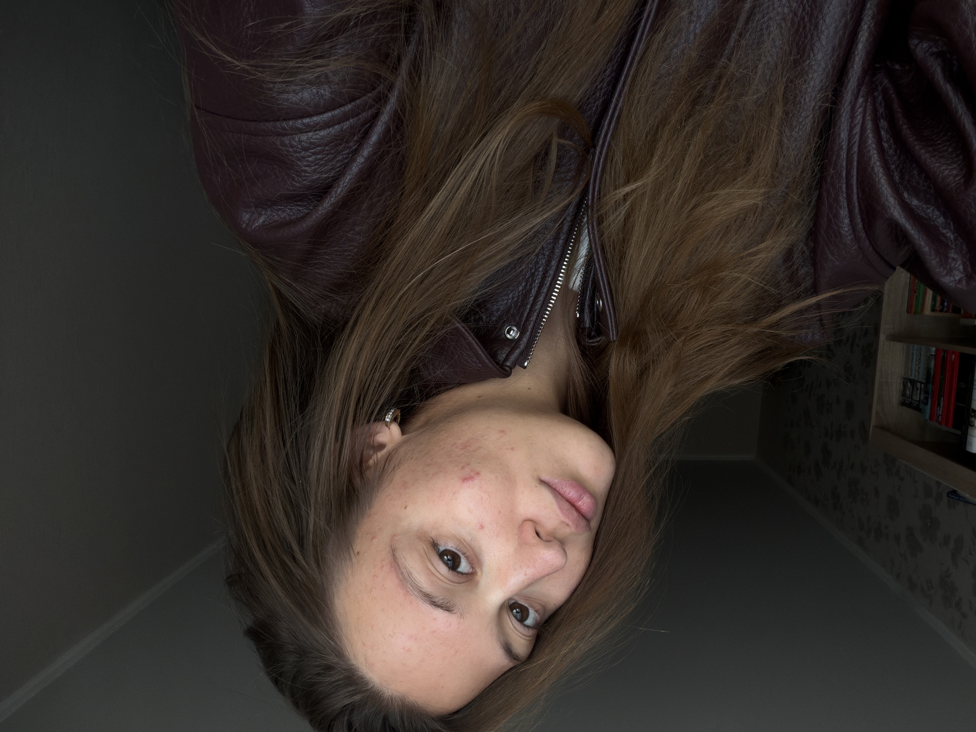 Woman photographed upside down indoors in Nakhodka, Russia