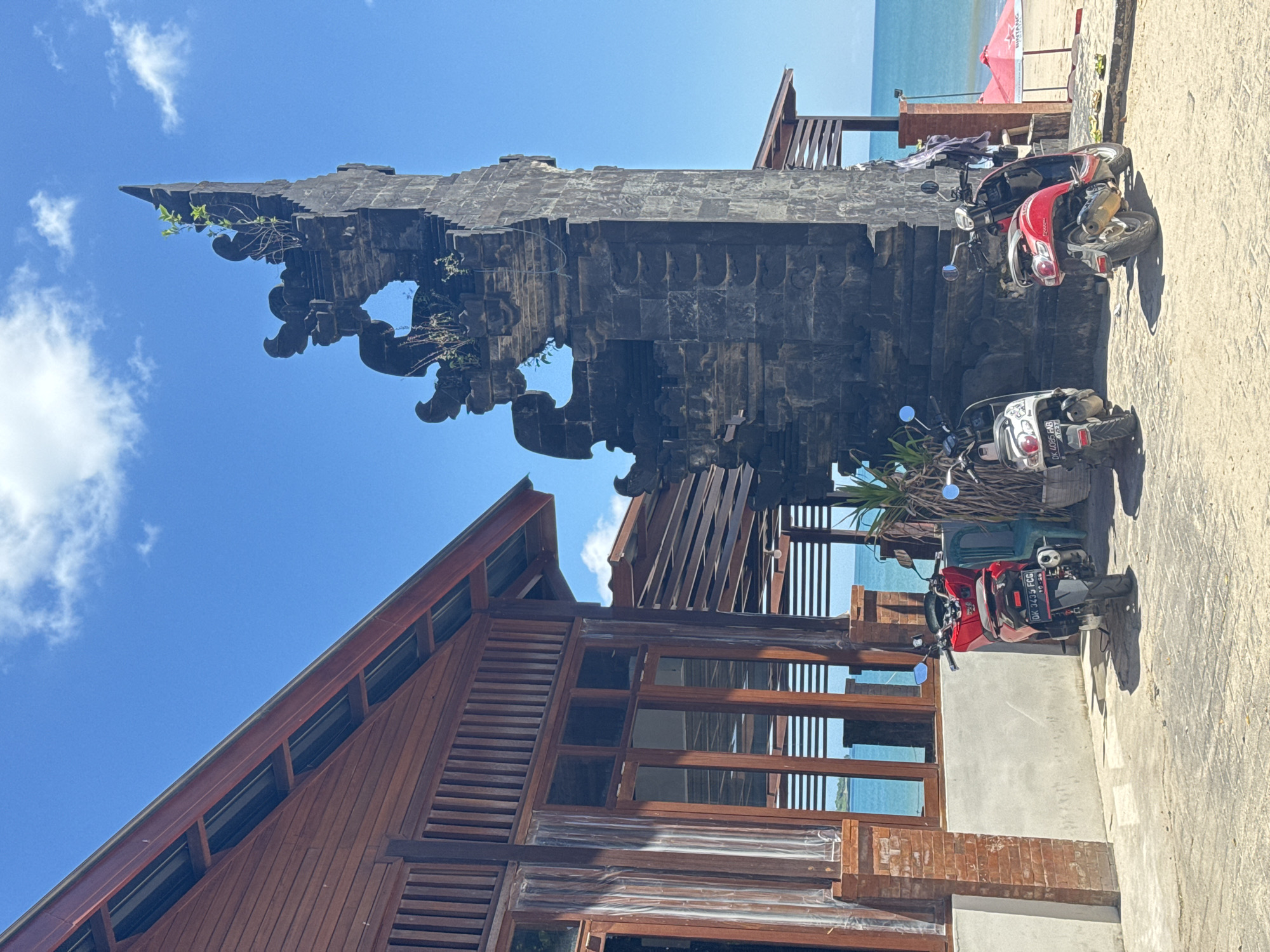 Urban scenes captured: Balinese gate, motorcycle rider, street market