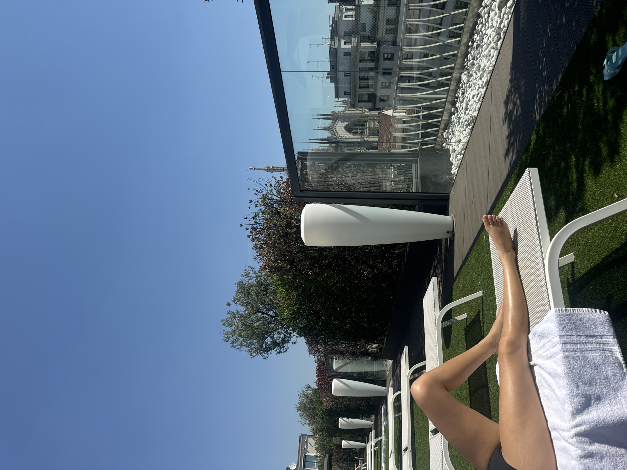 Rooftop lounging on a Milan terrace, summer morning