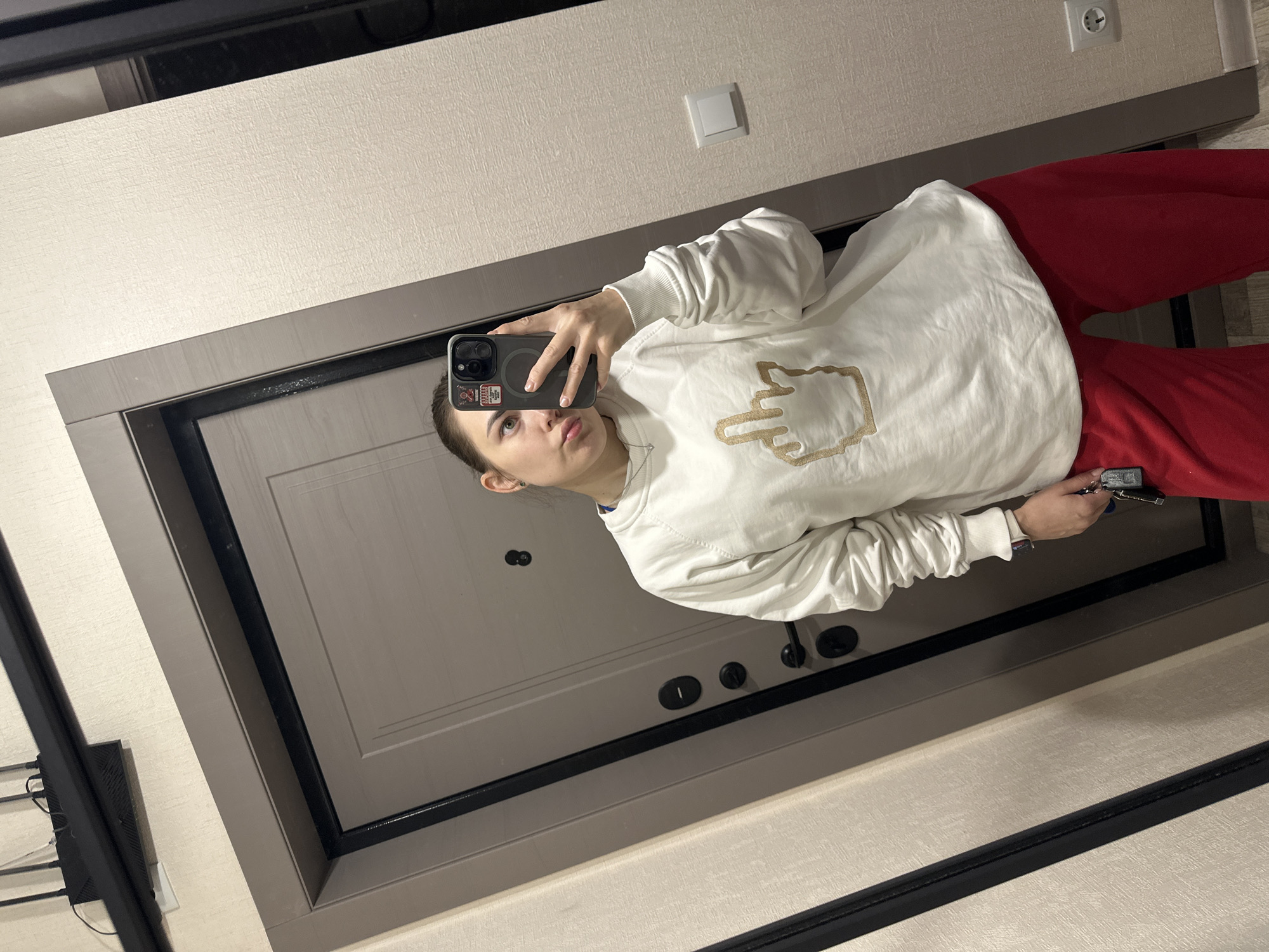 Woman takes mirror selfie in Perm apartment