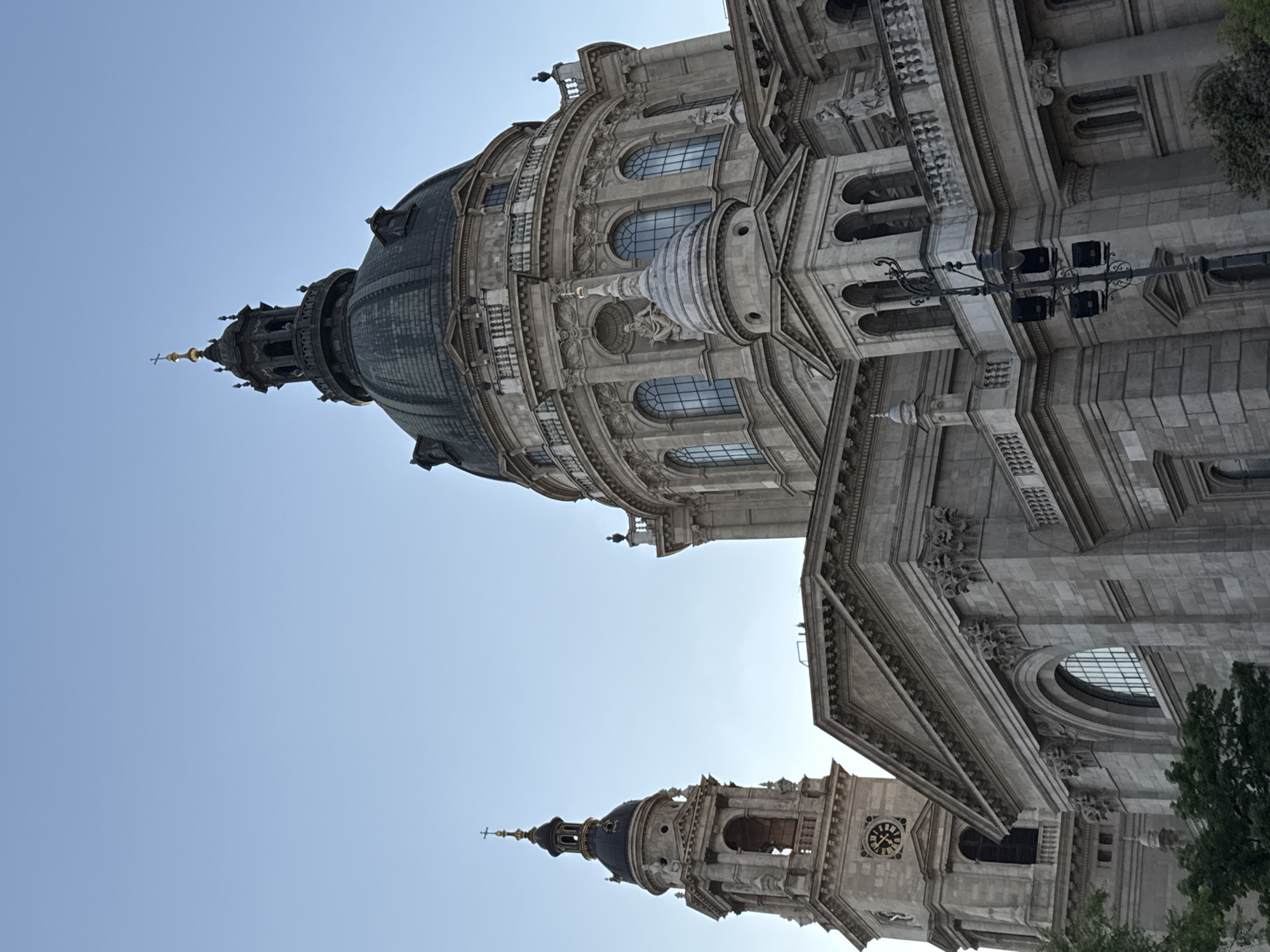 Tourist photographs St. Stephen's Basilica from multiple angles in Budapest