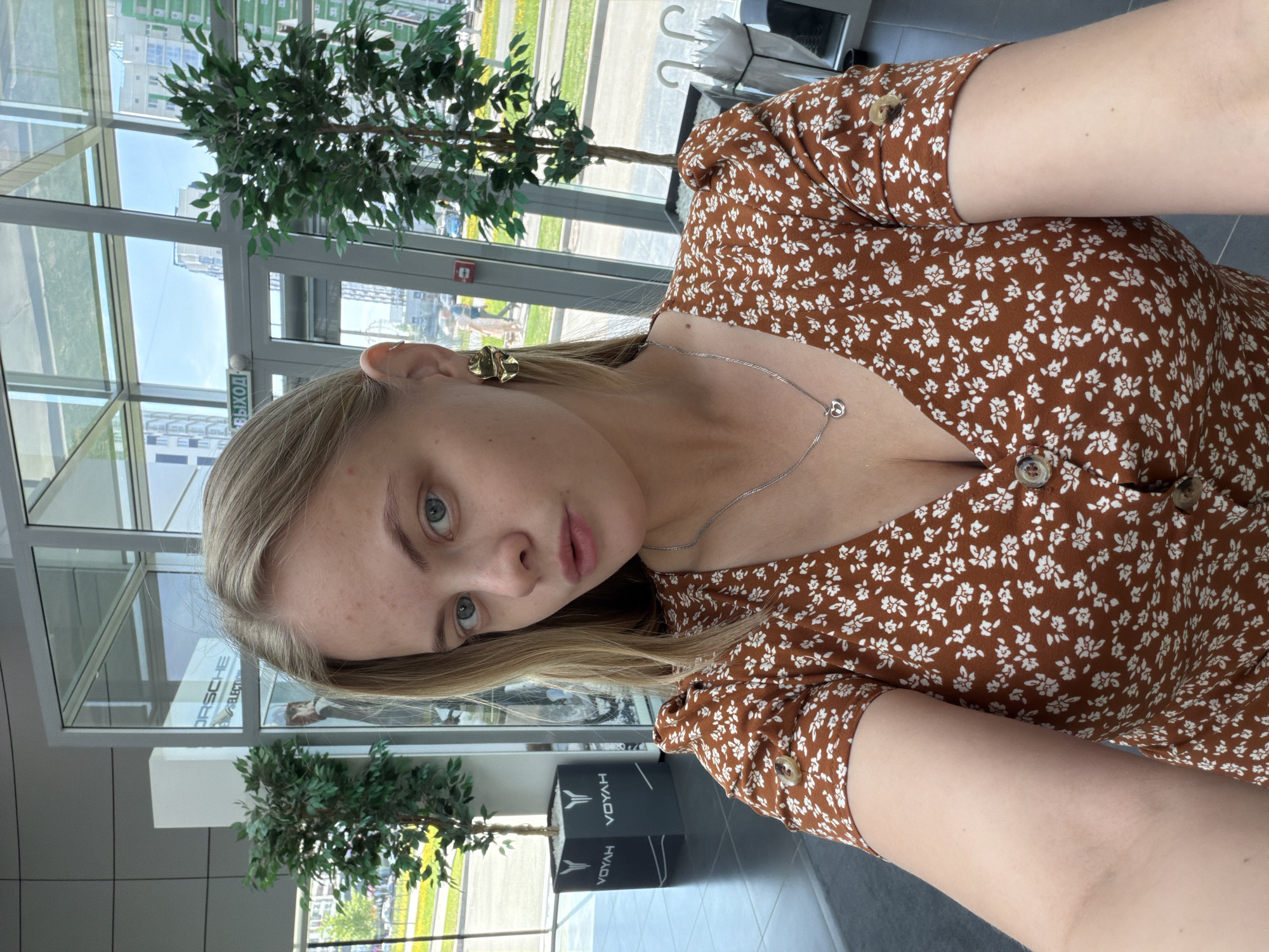 Woman takes selfies in brown floral dress, Izhevsk
