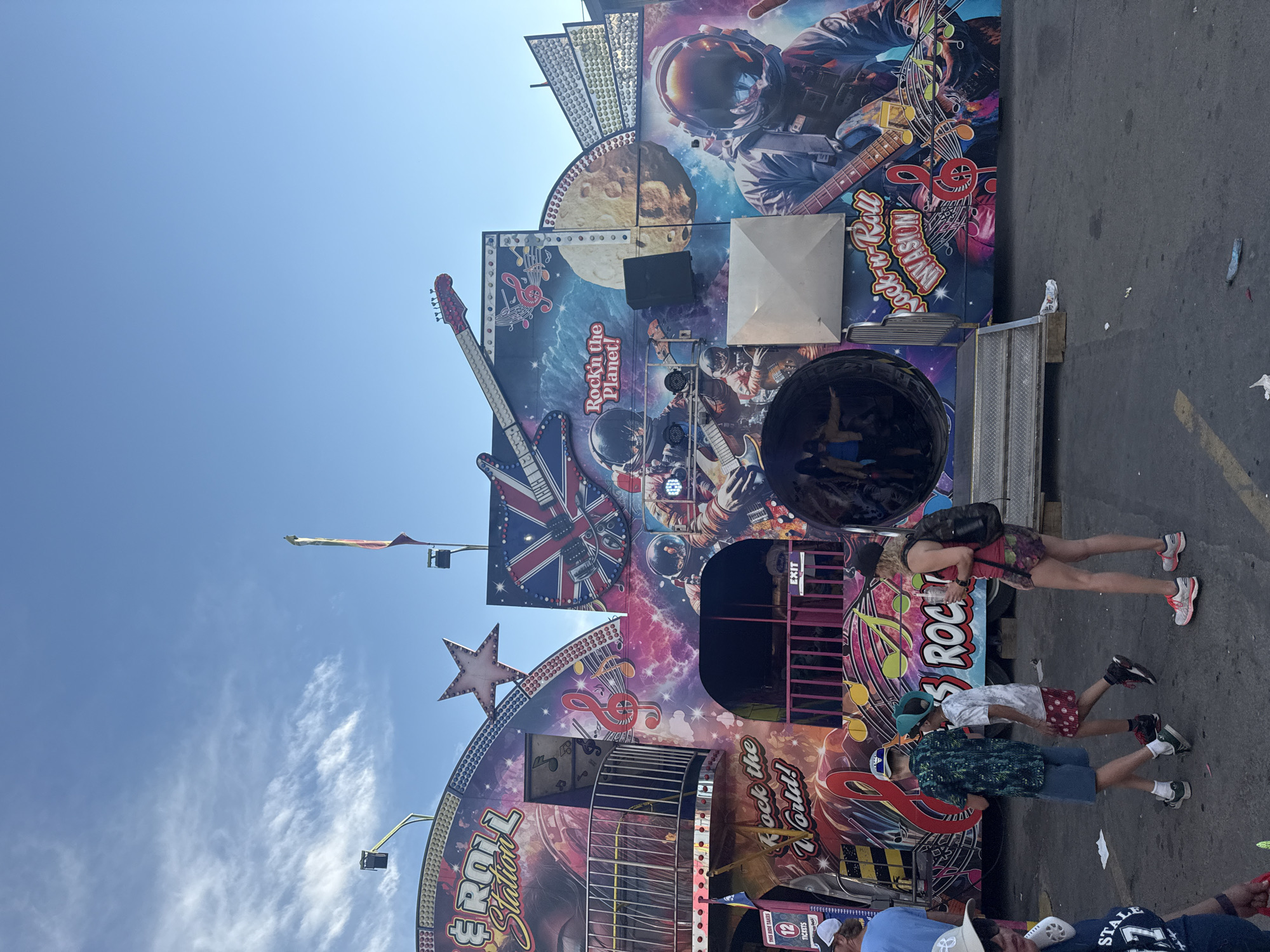 Calgary carnival: rides, game booths, and a teal Ferris wheel