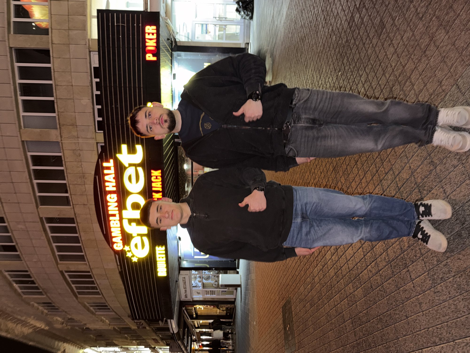 Two men explore illuminated historic Plovdiv at night