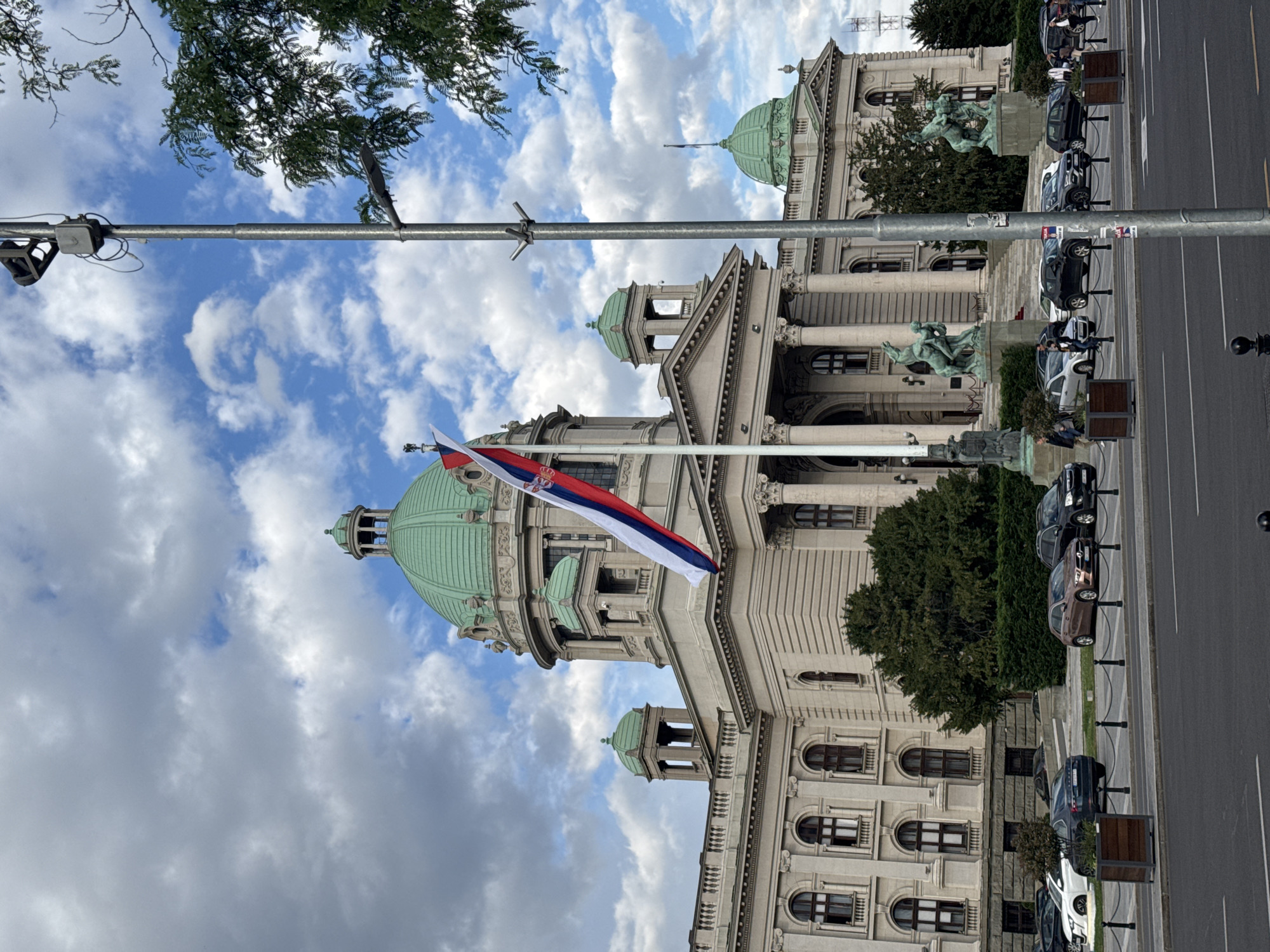 Tourist documents afternoon stroll through central Belgrade with drinks