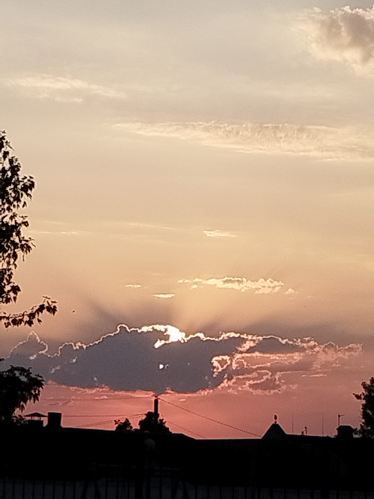 Crepuscular rays and soft color at sunset over Brest
