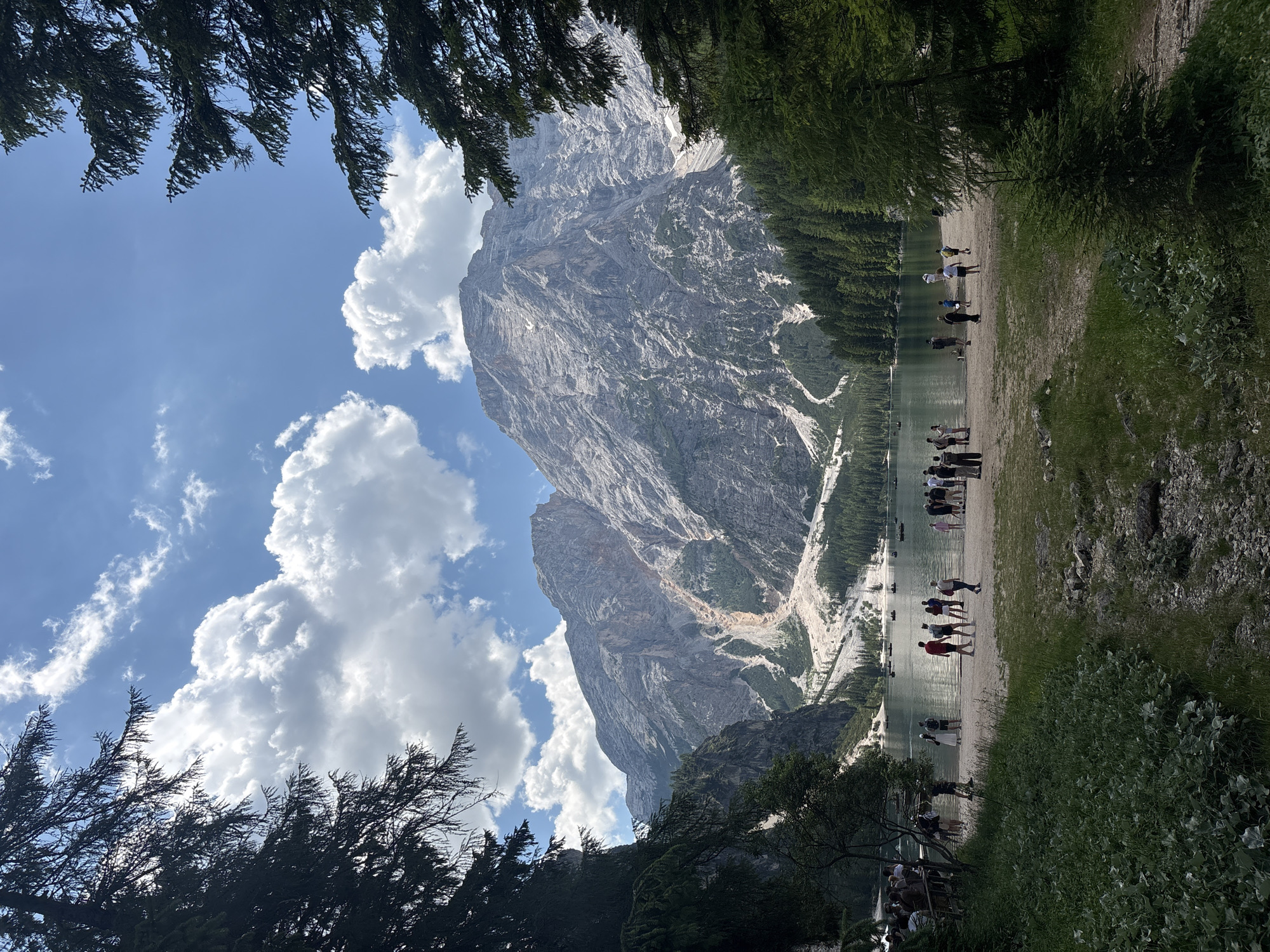 Morning at an alpine lake: hotel, trails, and a dog in the shallows