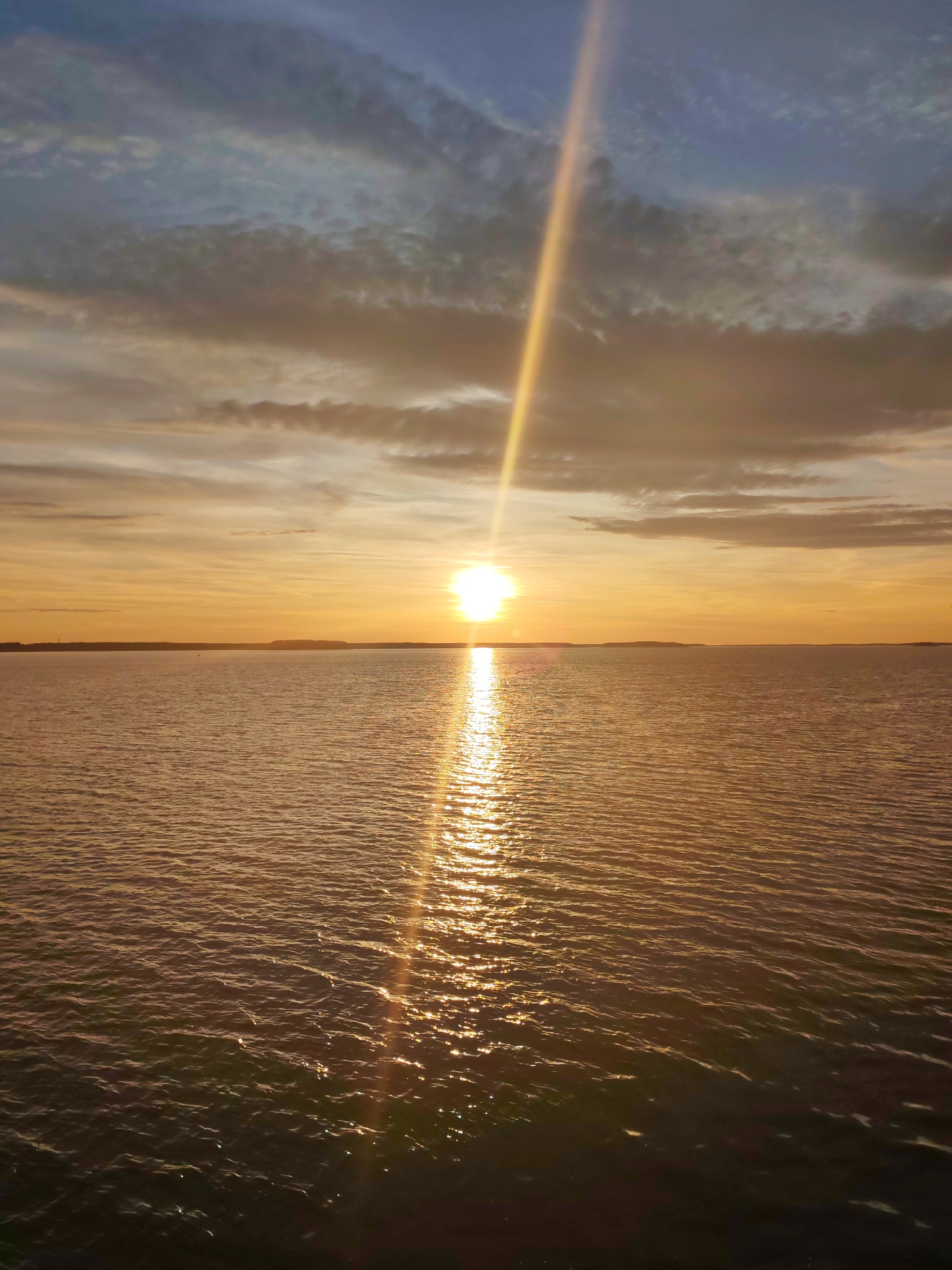 Sunset observed from ship deck over water body