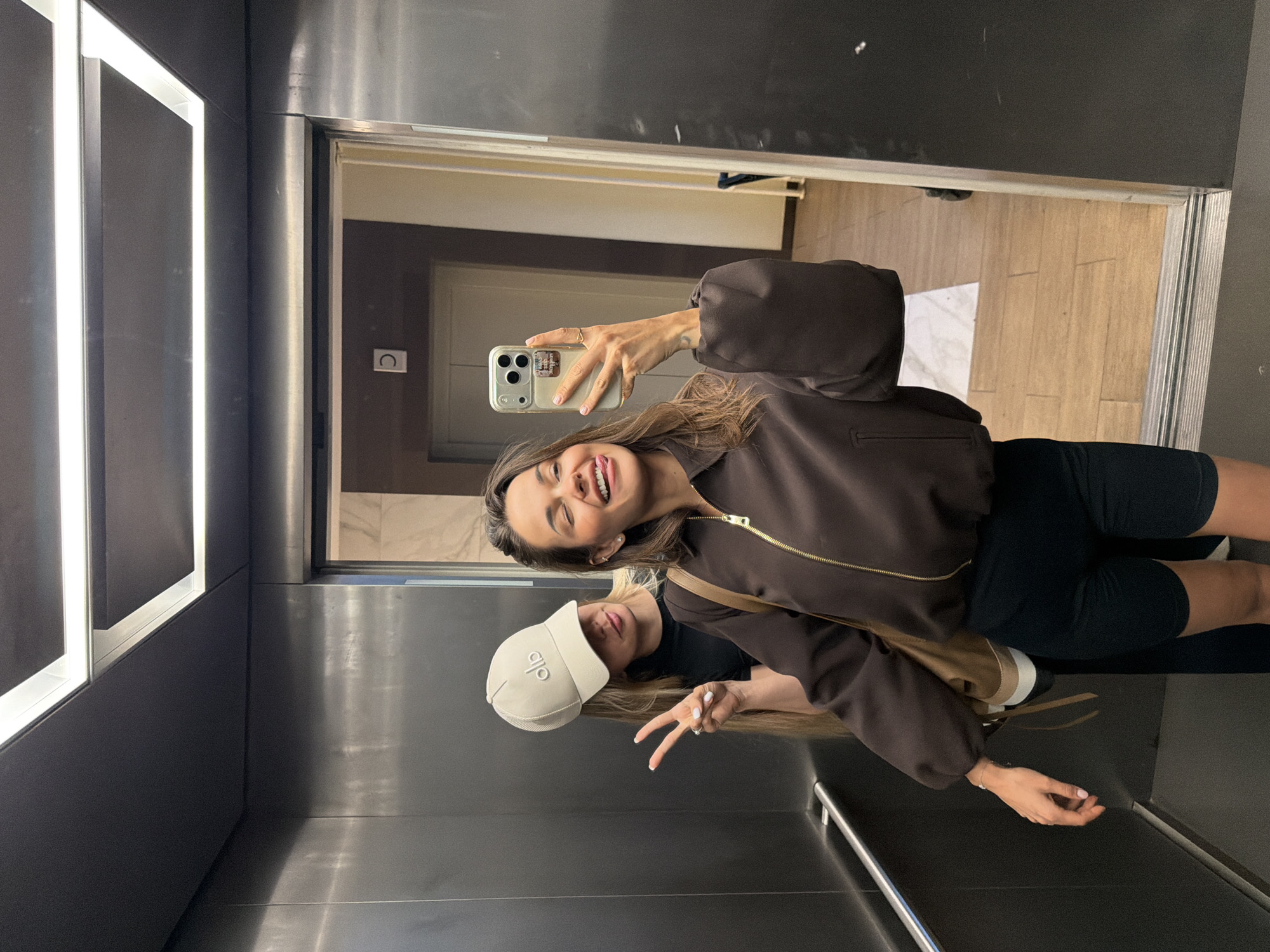 Mirror selfie in a Moscow elevator, June 2026