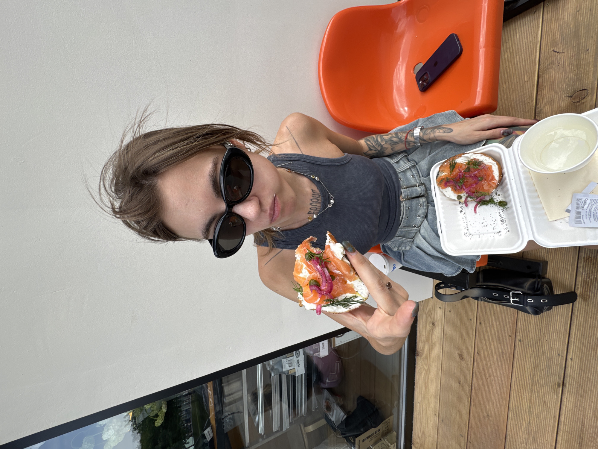 Woman enjoys salmon bagel lunch in Moscow