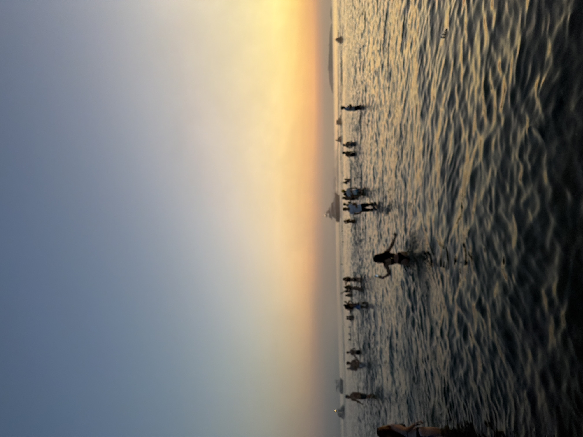 Sunset crowd wading in the shallows at Sozopol's waterfront