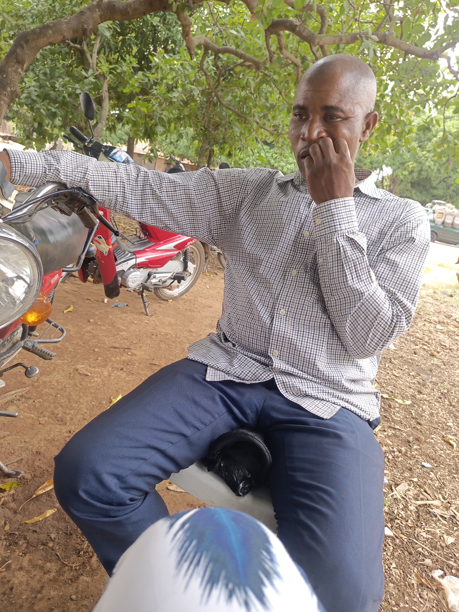 Two men gather under trees in Andaha, Nigeria