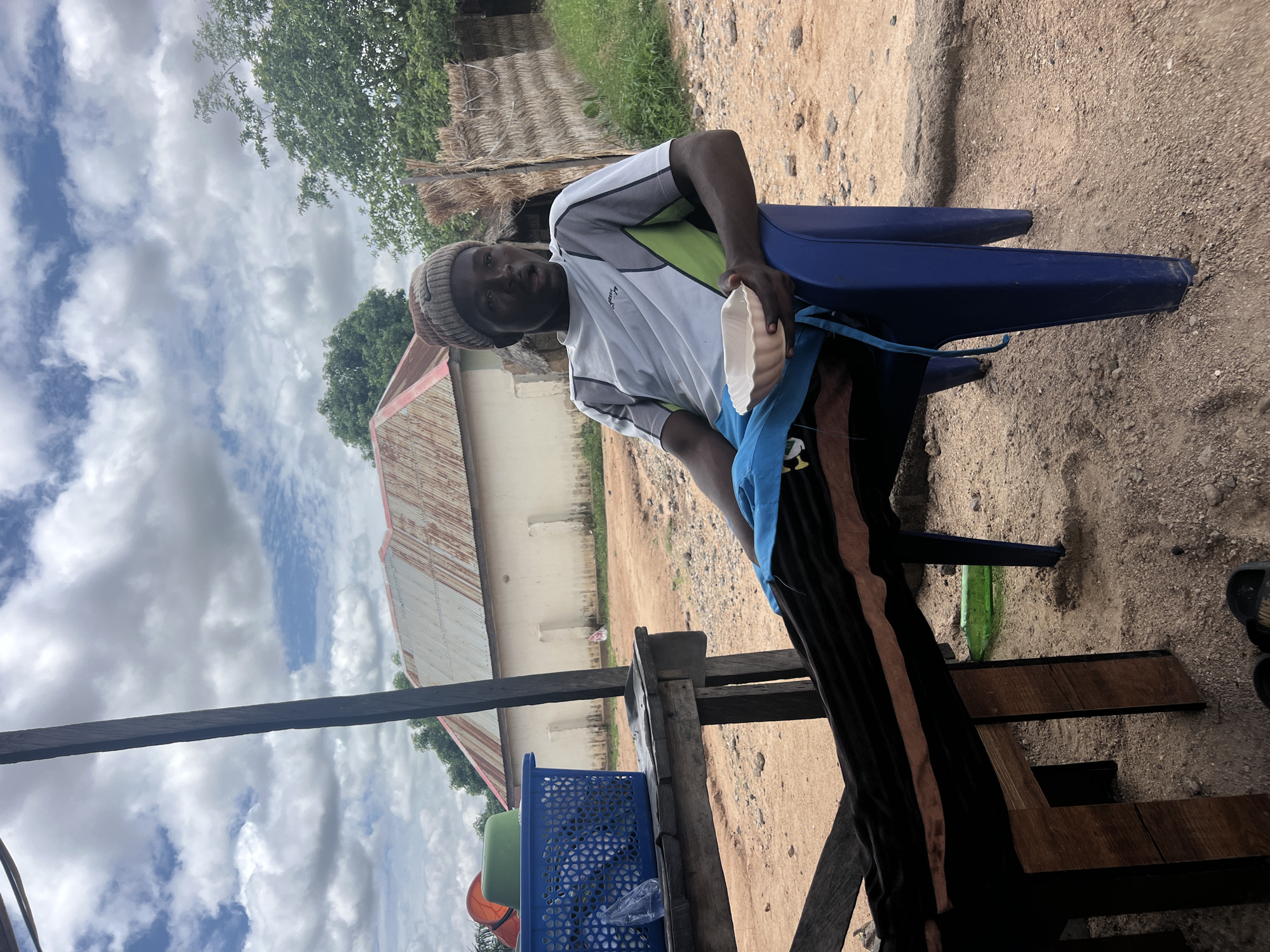 Young man rests under shelter in Howayi, Nigeria