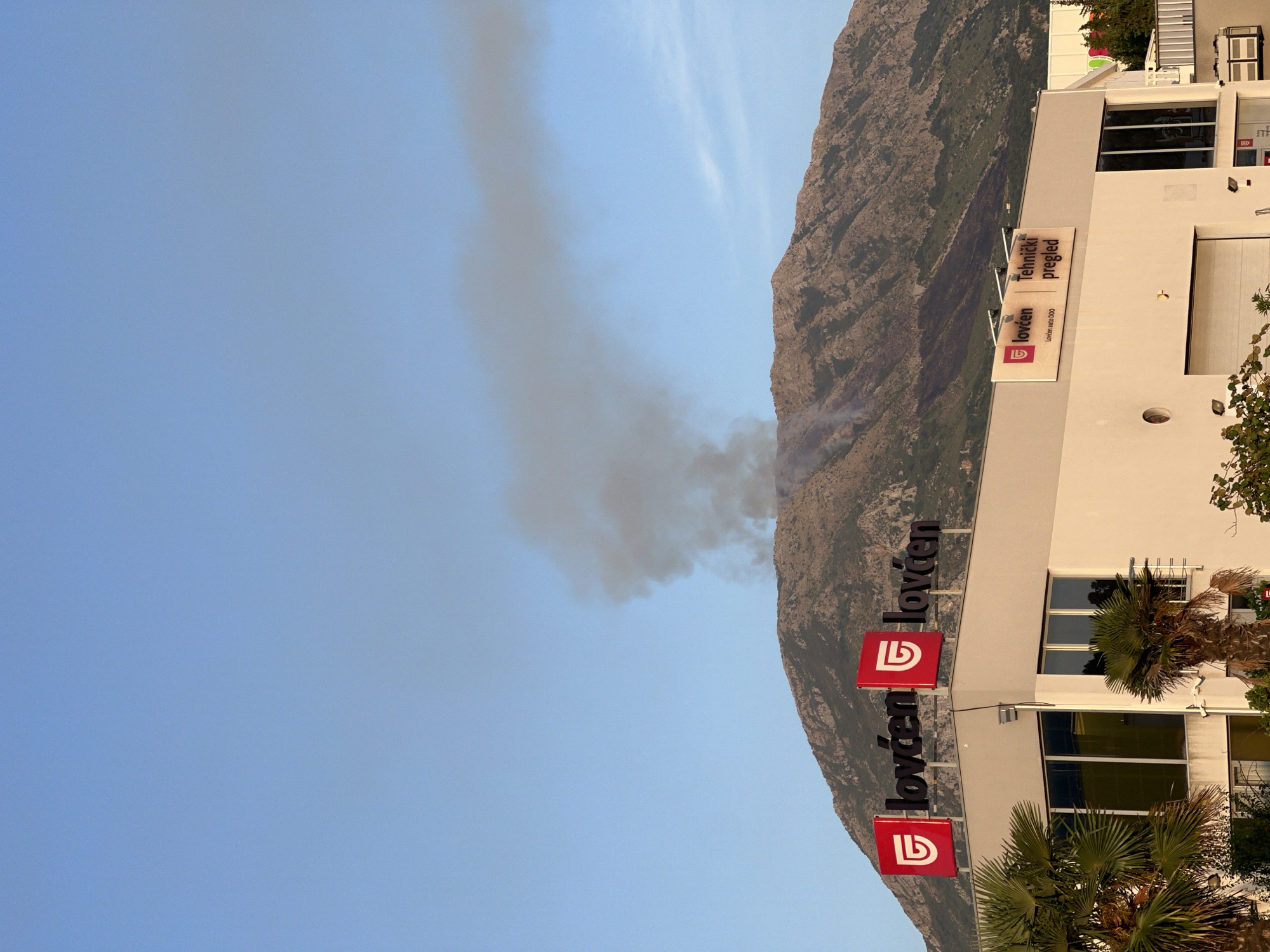 Mountain fire burns above Bjeliši, Montenegro, sending up dark smoke