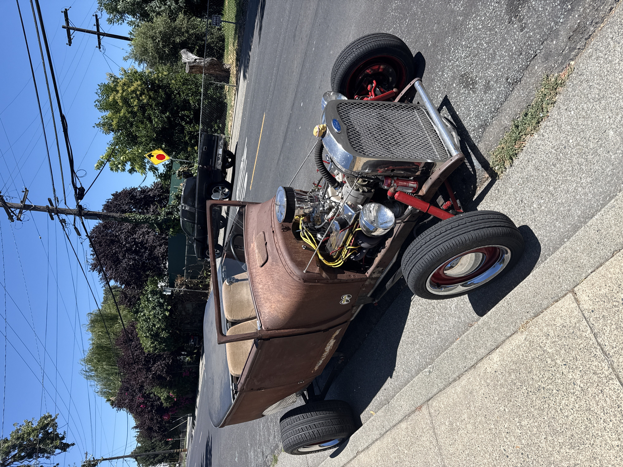 Exposed-engine hot rod parked on a West Sacramento street