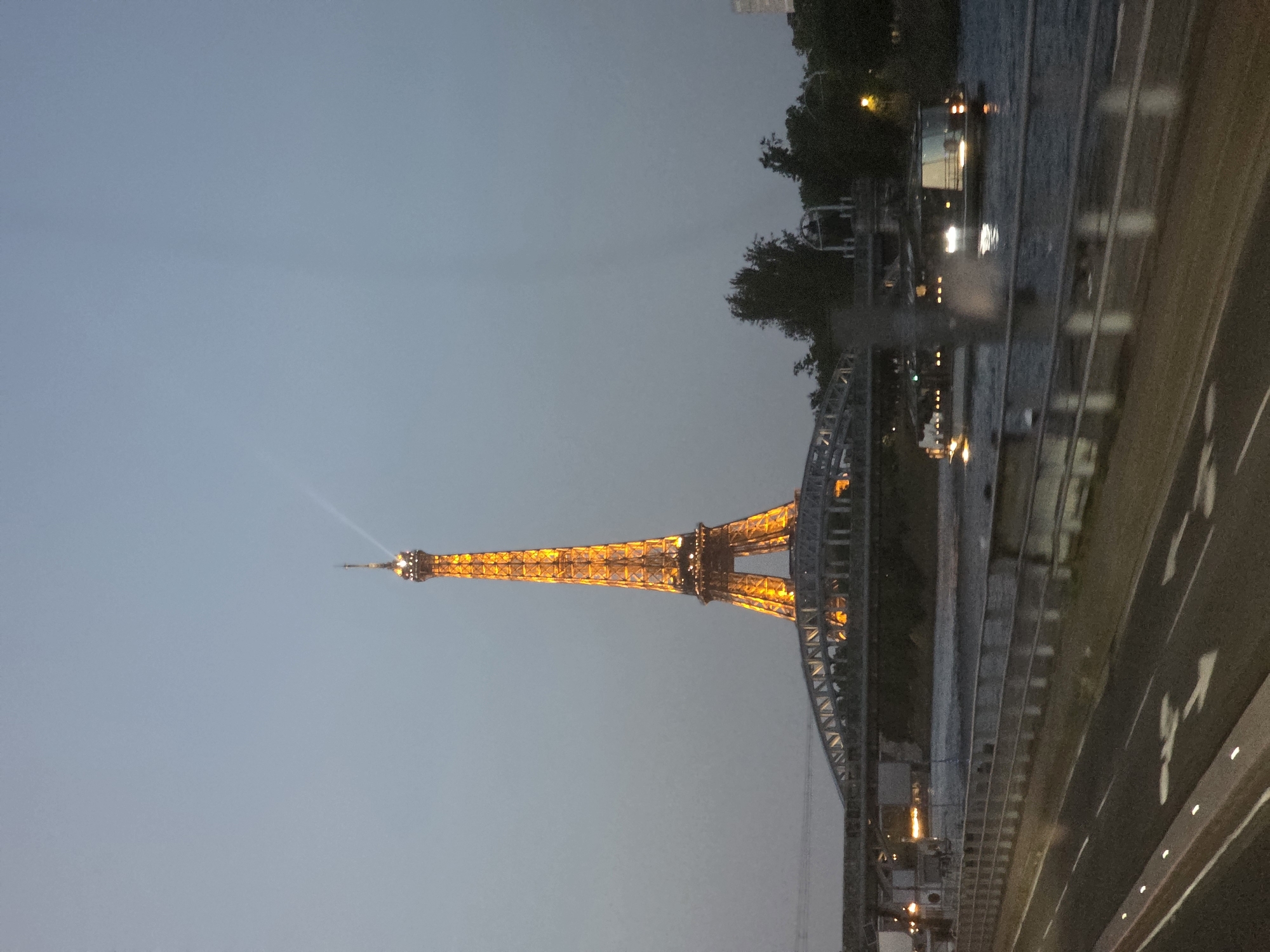 Eiffel Tower glowing gold at dusk, Paris