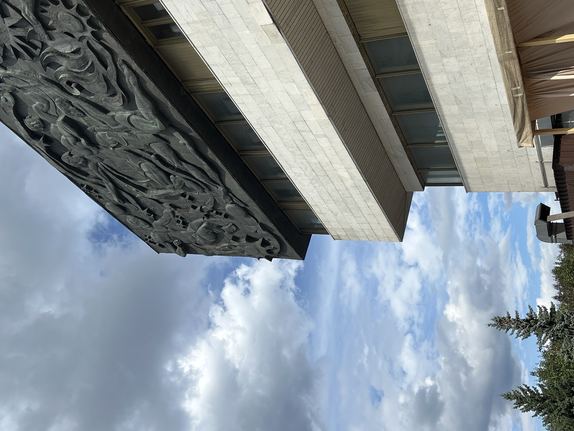 City architecture, public sculpture, and street scenes on a cloudy day
