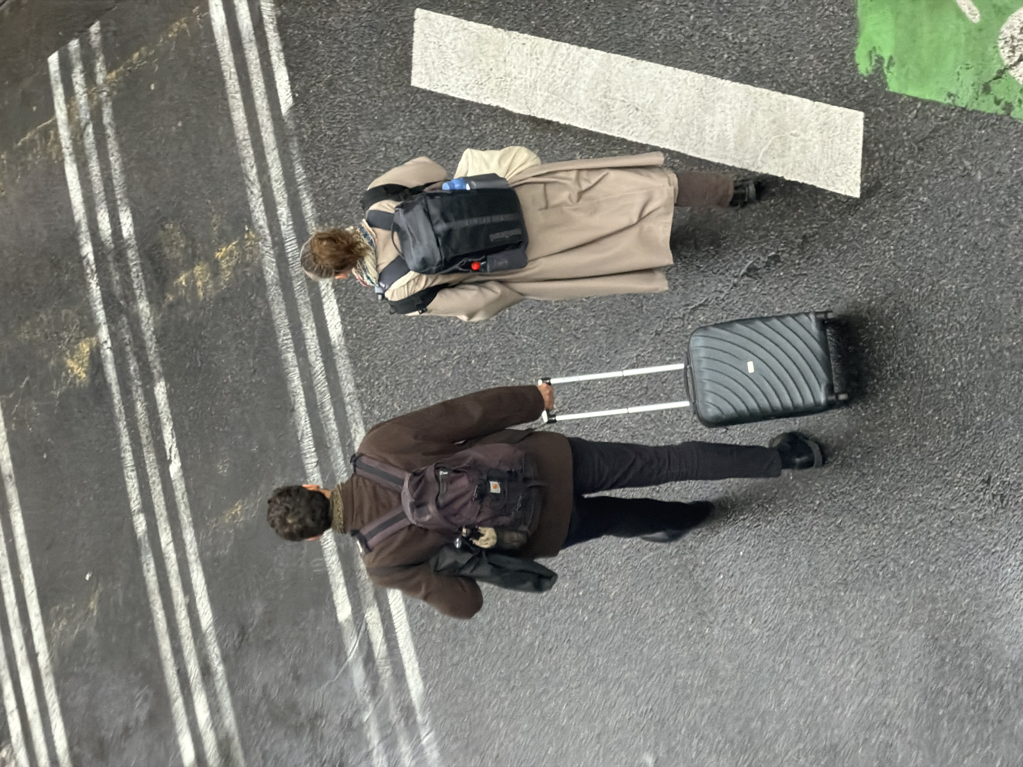 Pedestrians navigate wet Paris street after rain