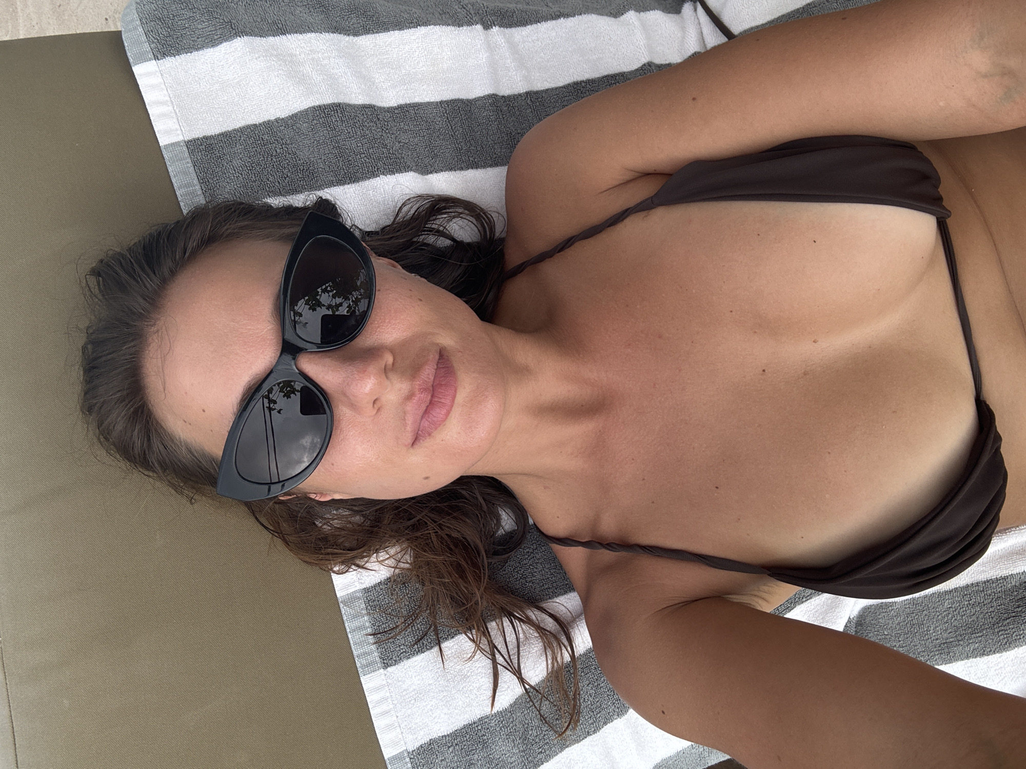 Woman enjoys morning beach time with beer in Indonesia