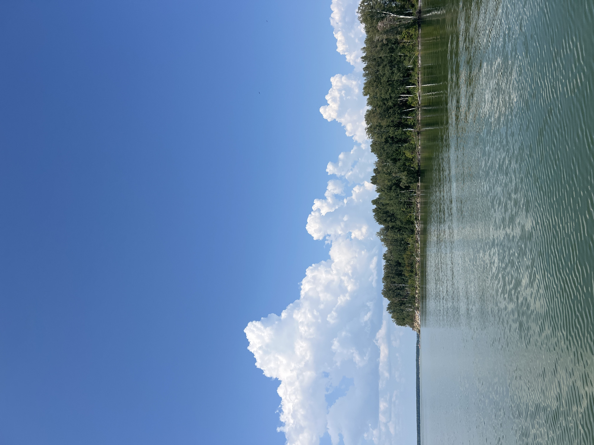 Calm lake morning in Bystrovka with a boat crossing