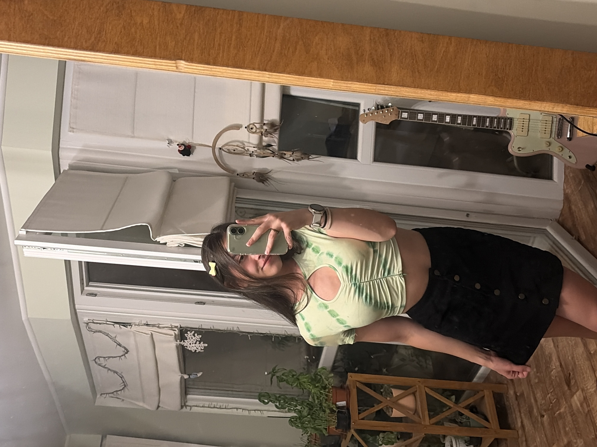 Mirror selfie and spray-painted ram on a dark surface