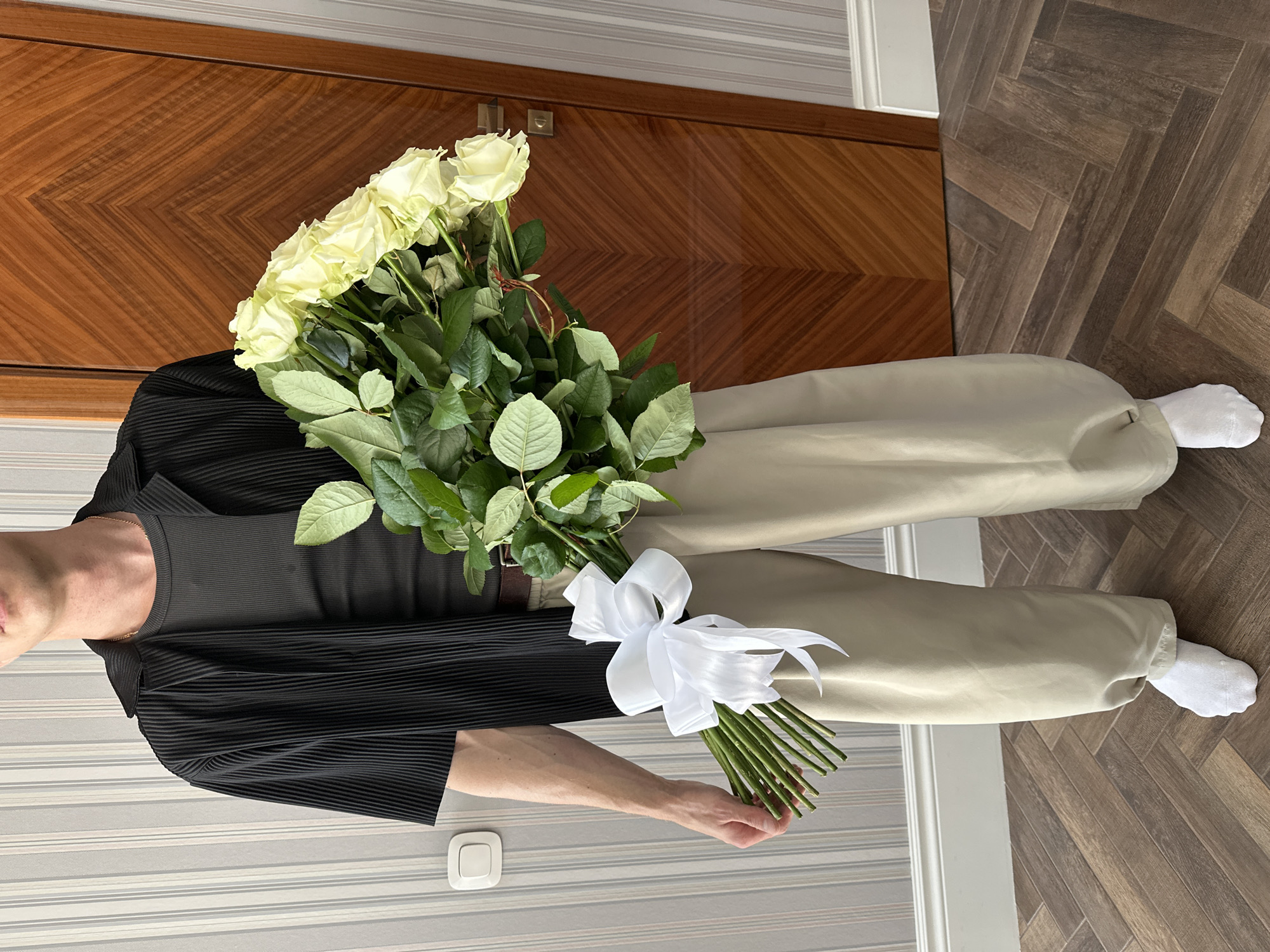 Man with white roses captured in Krasnodar cityscape memories