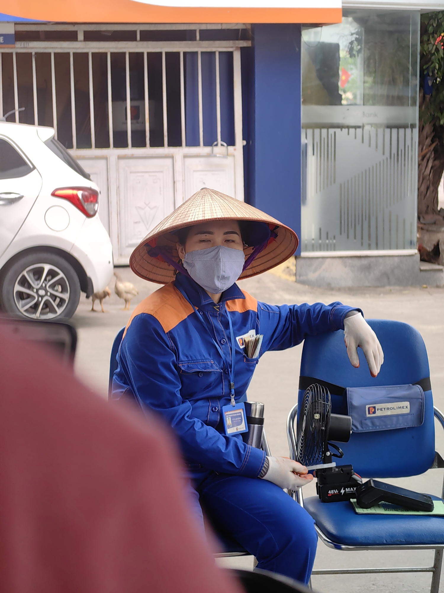 Uniformed woman in traditional hat observed in Vietnam