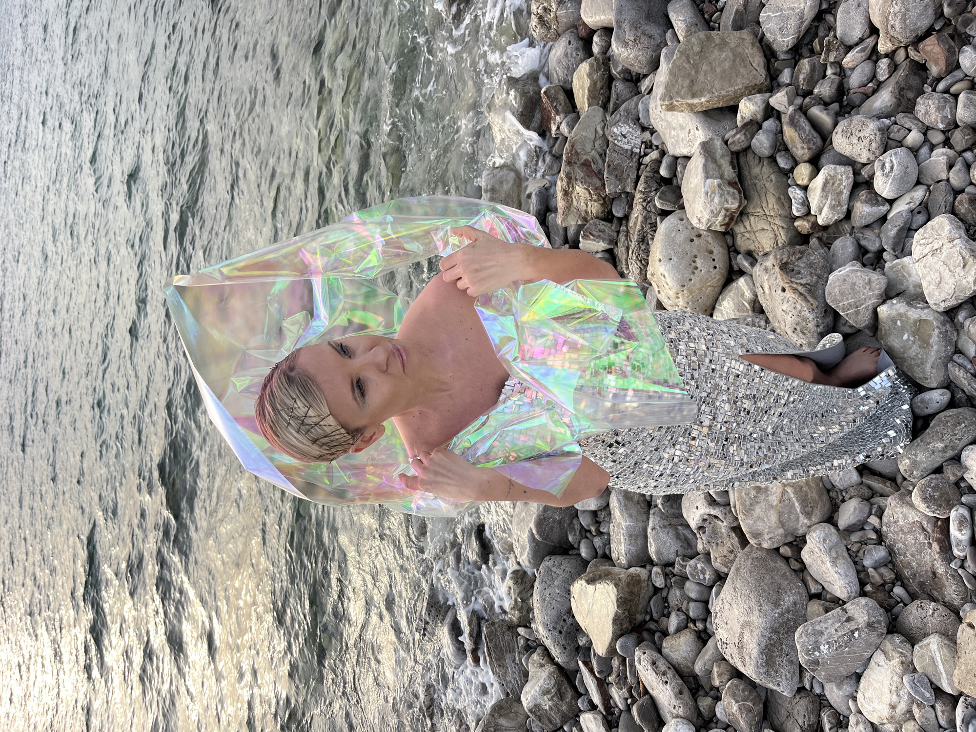 Woman poses on rocky beach in Buljarica, Montenegro
