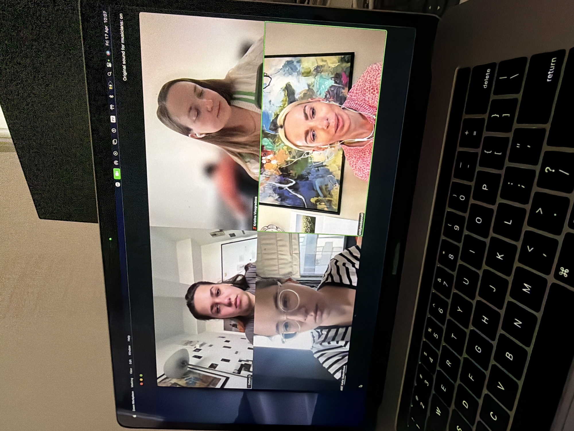 Video conference session observed on angled laptop in Como