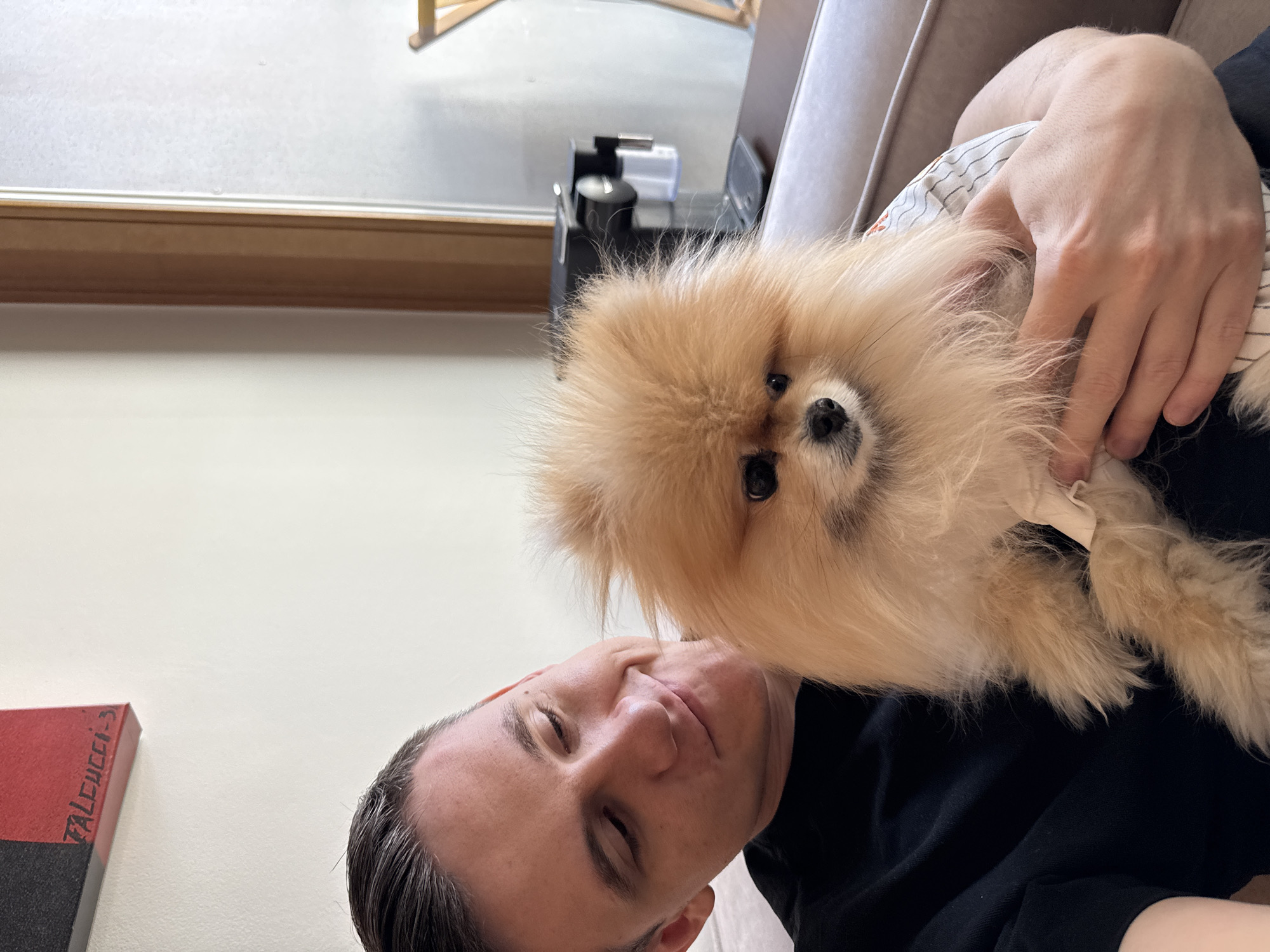 Man with Pomeranian dog at Warsaw cafe