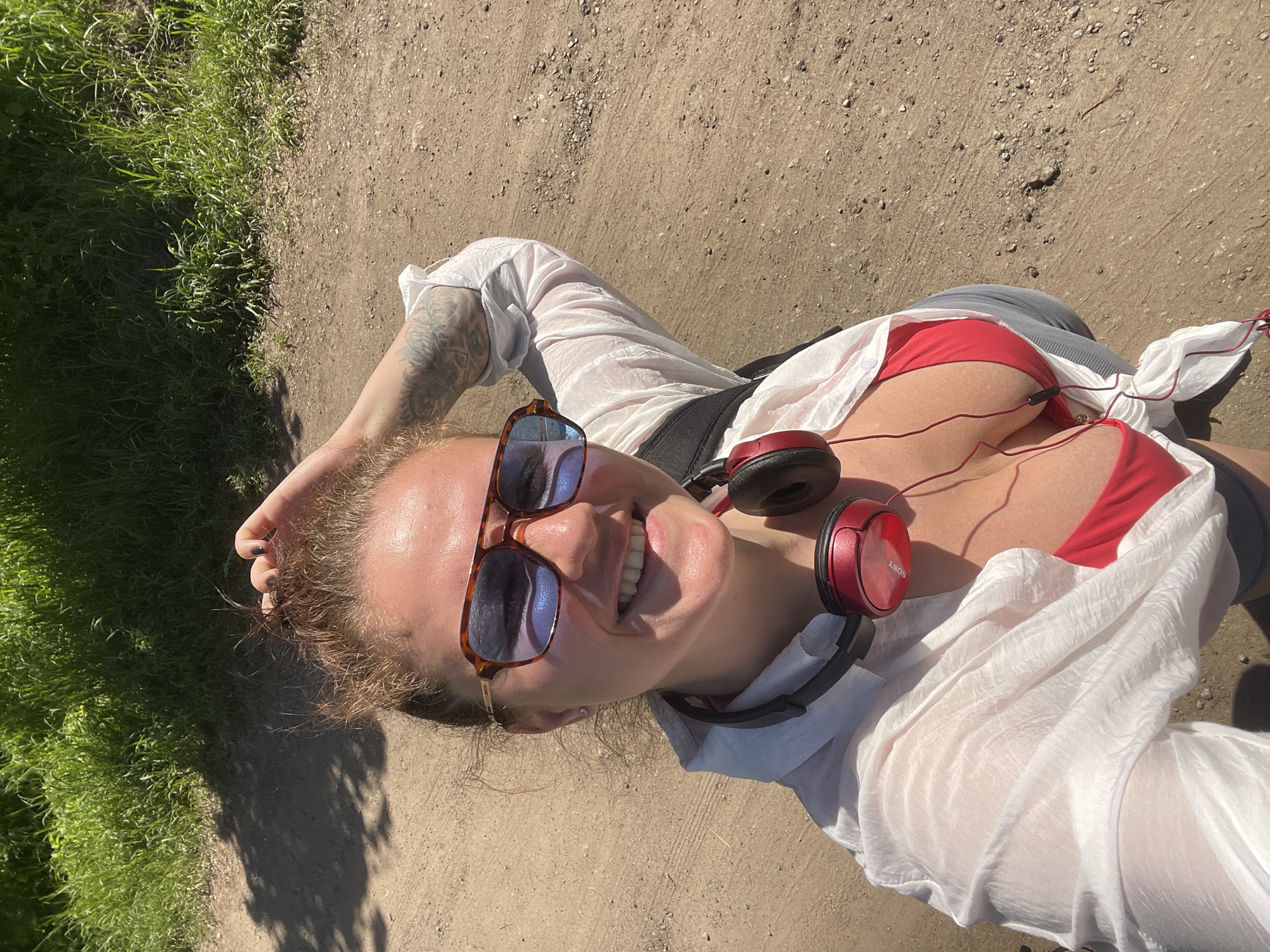 Woman rests on dirt path in Ostrov wearing swimwear