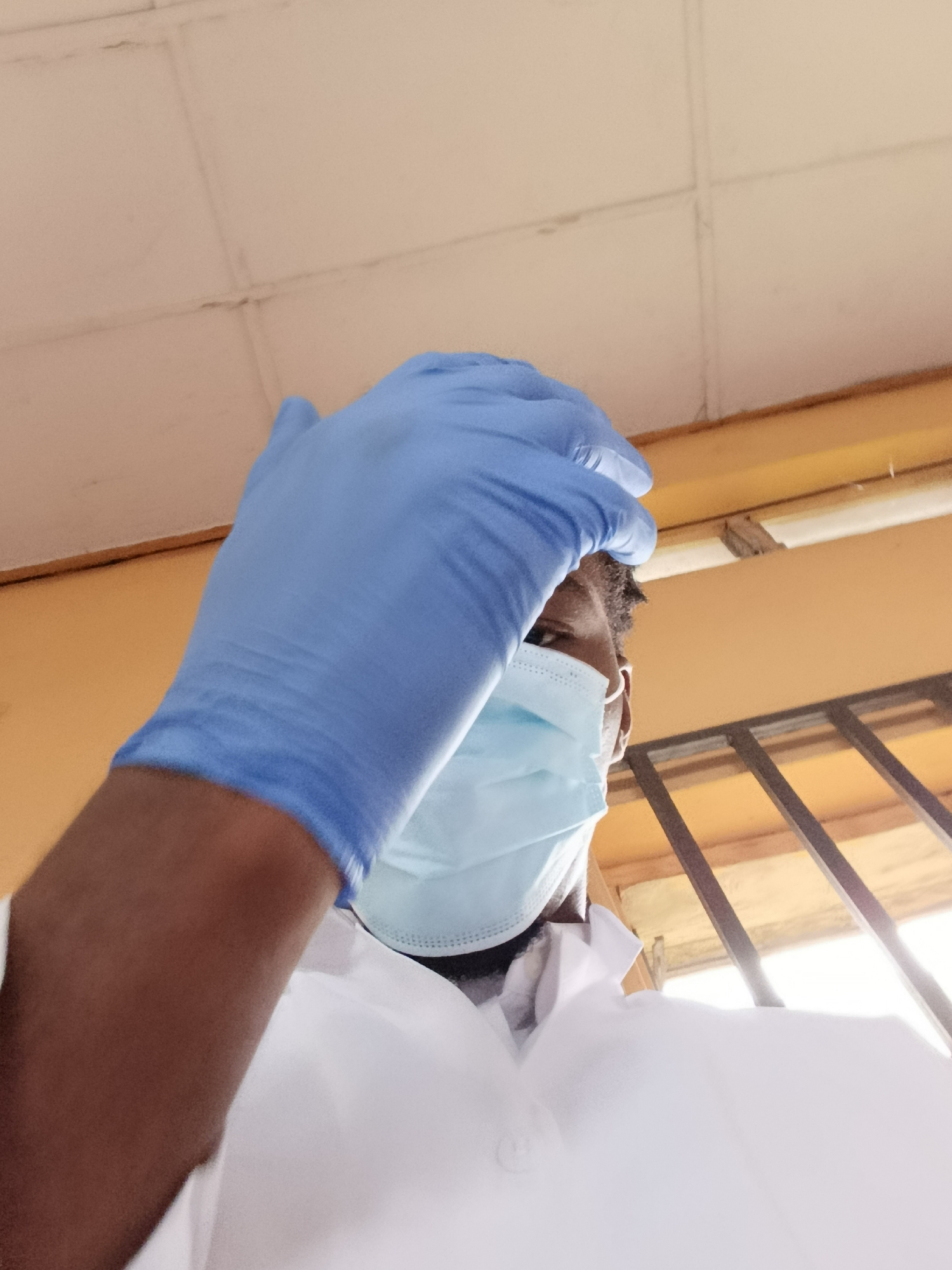 PPE, a wooden sculpture, and lab coats in the same minute