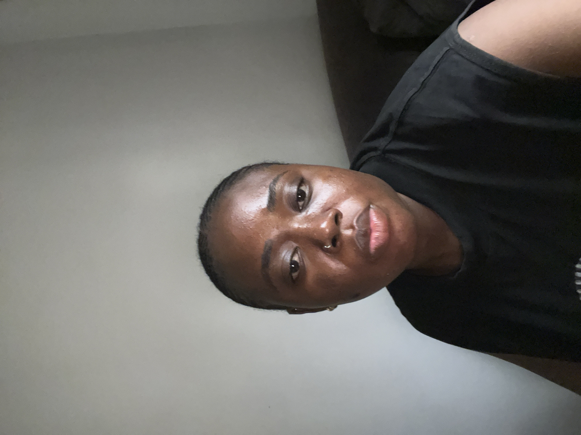 Young woman photographed across Abuja during rainy afternoon