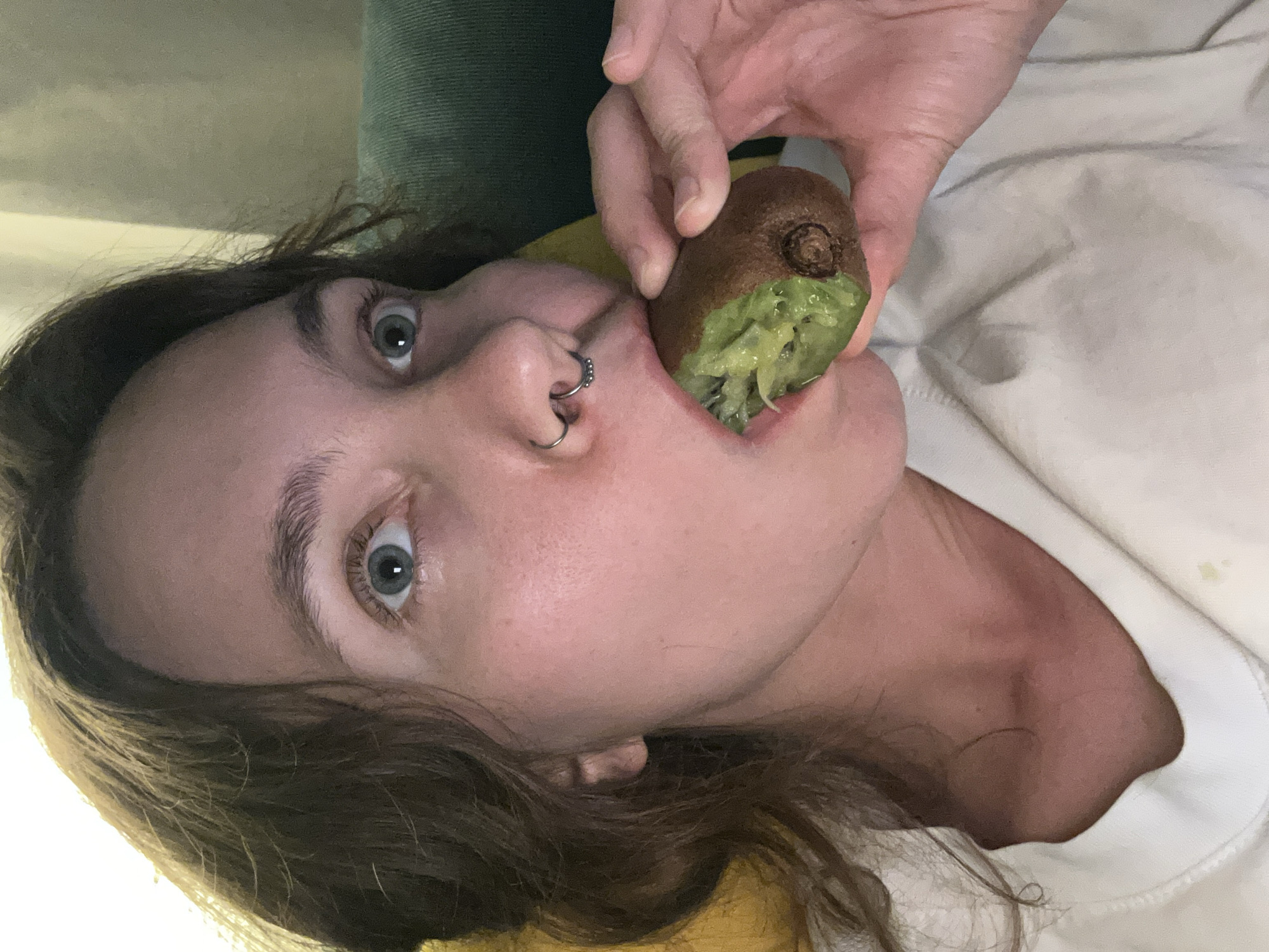 Woman eats kiwi fruit in Málaga, Spain