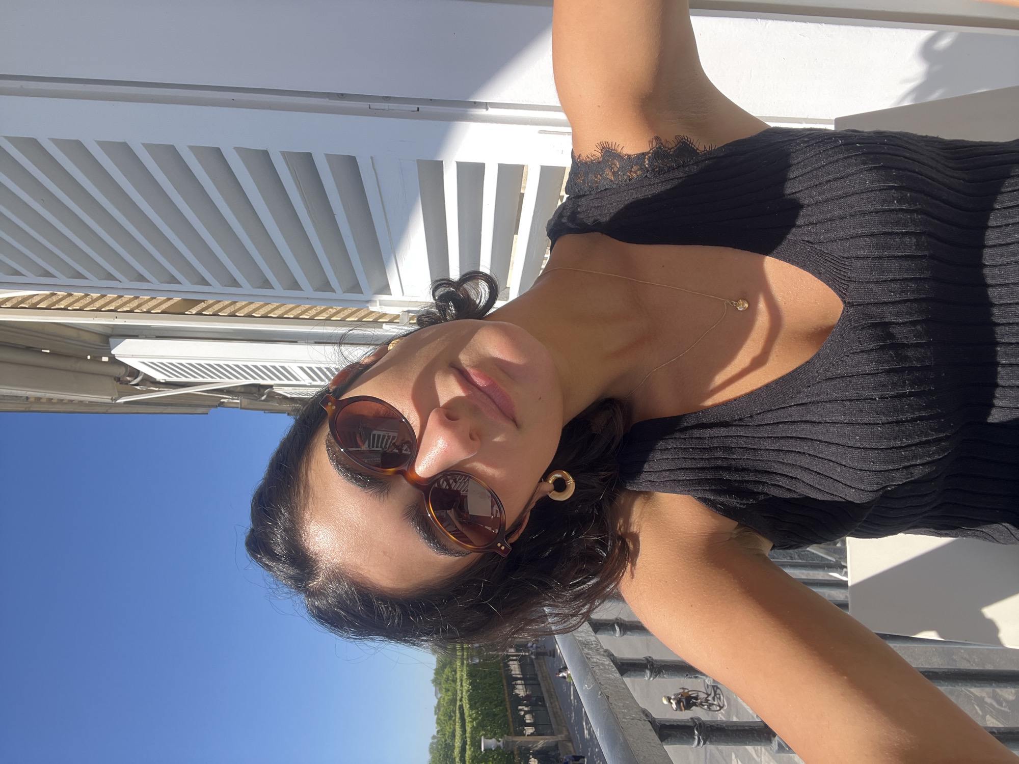 Woman enjoys sunny lunch on Paris balcony