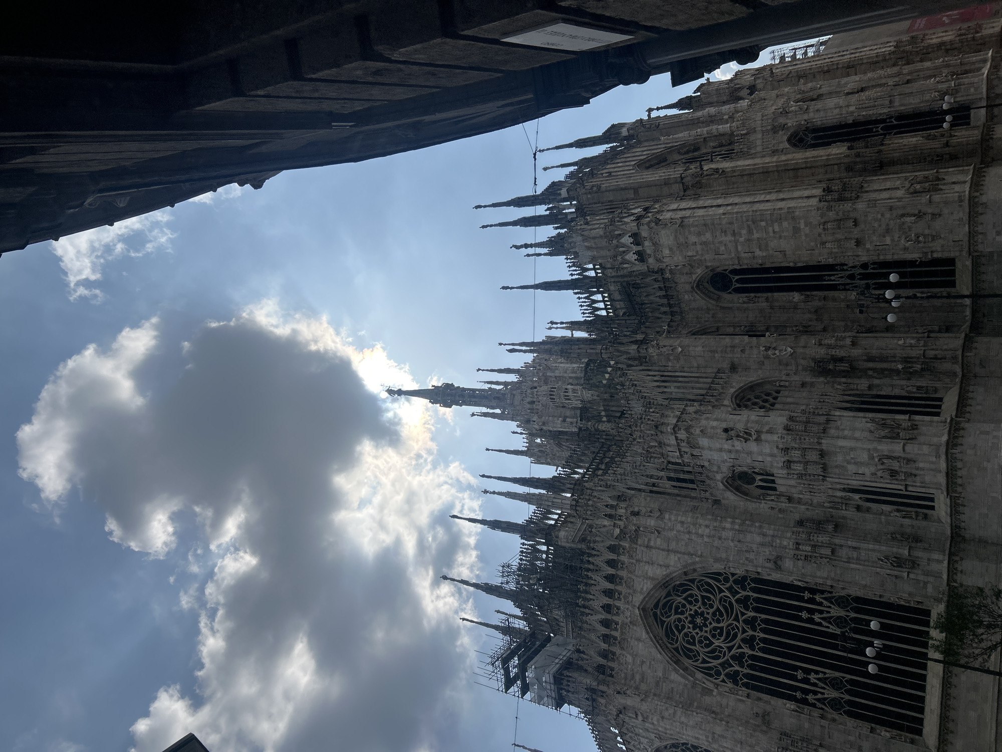 Milan Cathedral and film storefront photographed in afternoon