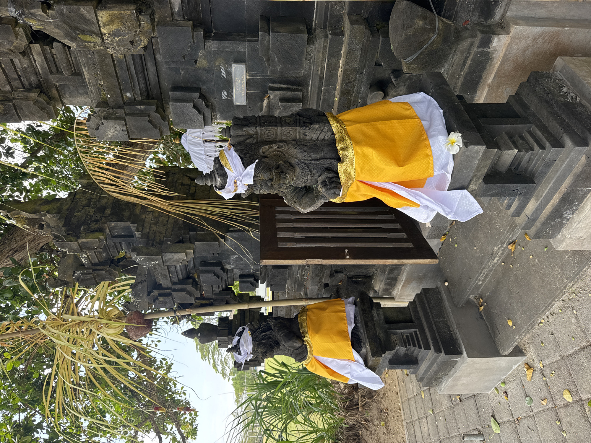 Balinese resort grounds with temples, gardens, and outdoor gym