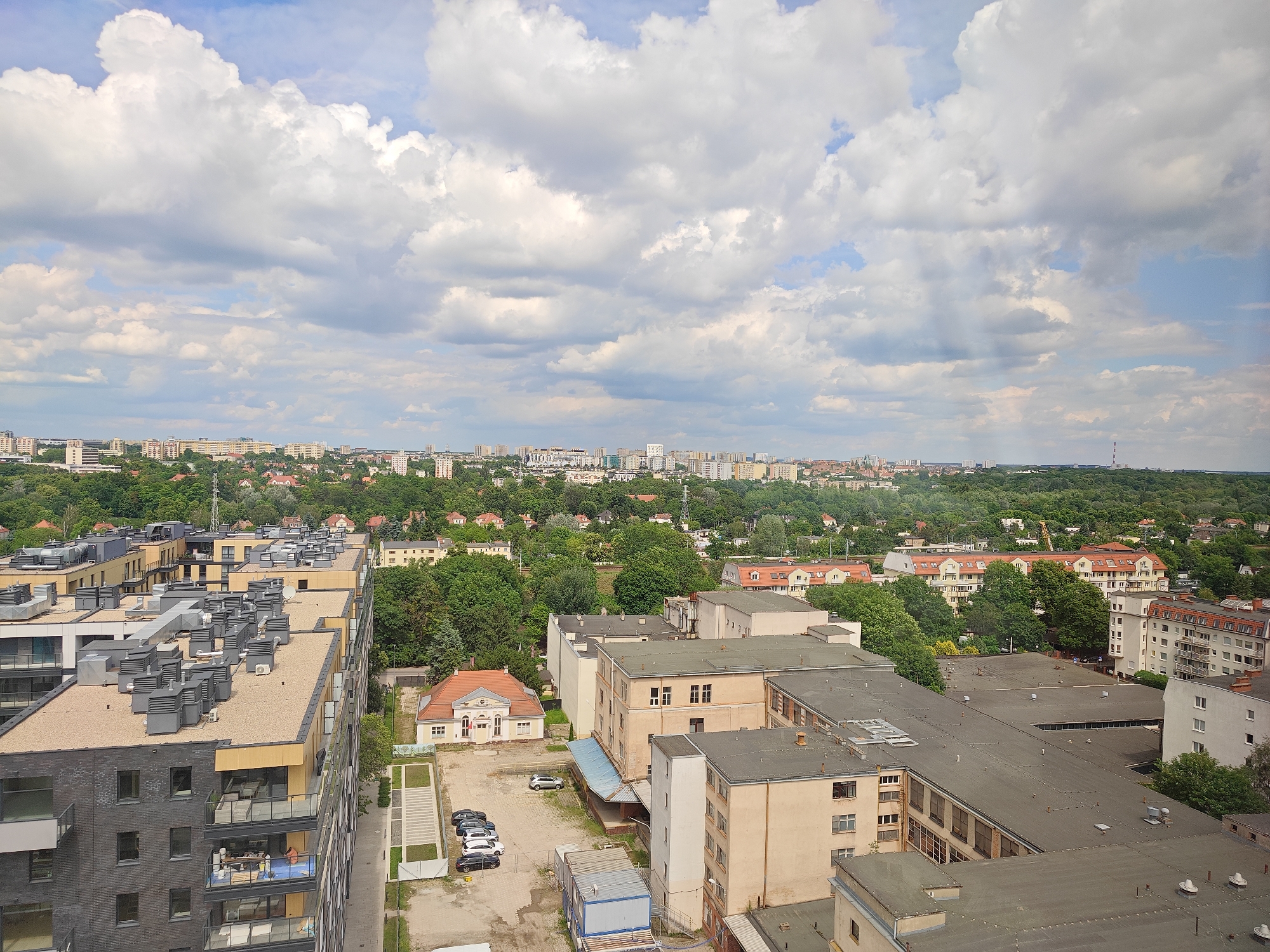 Crane operator documents workday views over Poznan cityscape
