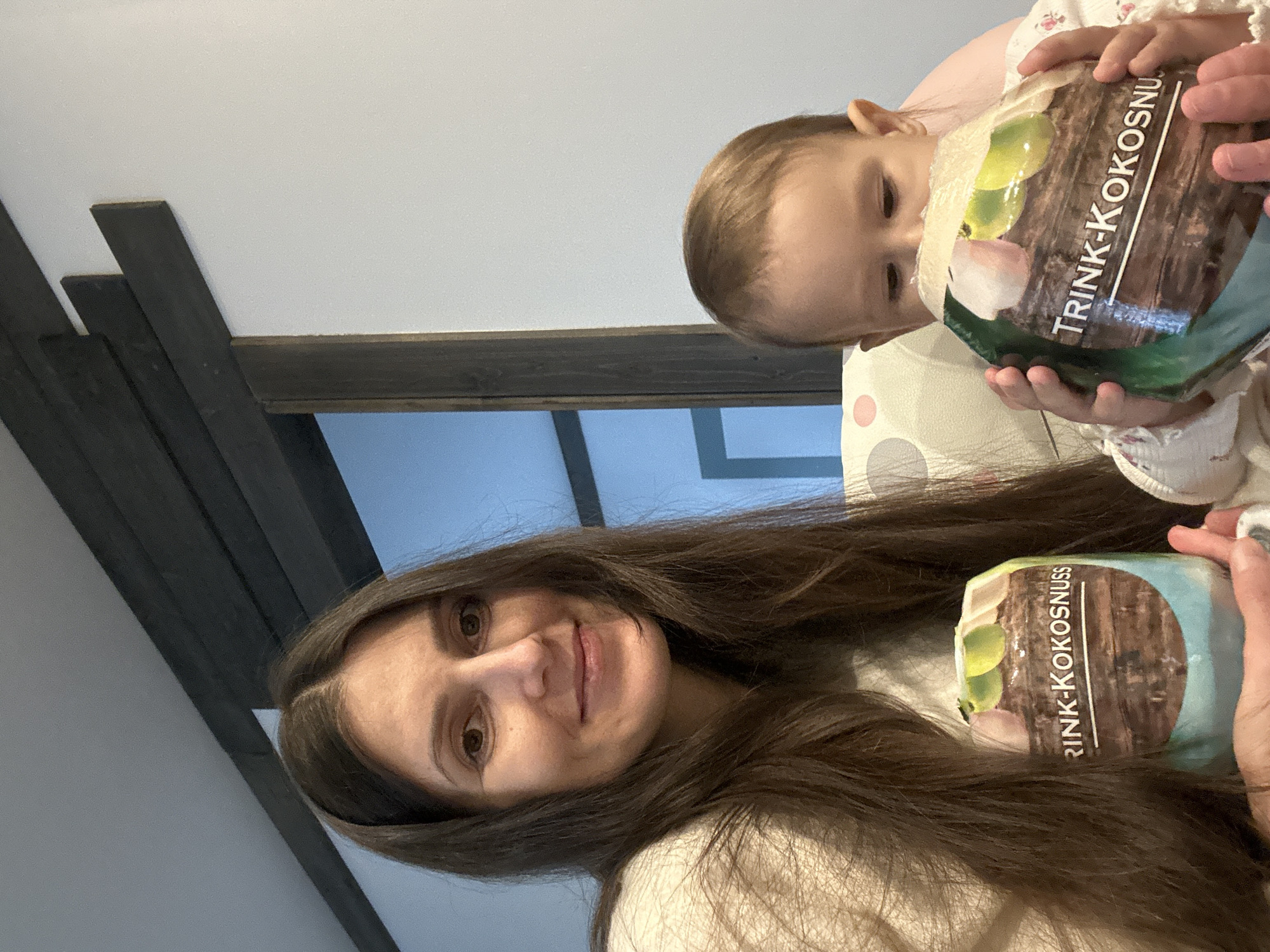 Mother and child share moment with coconut drink