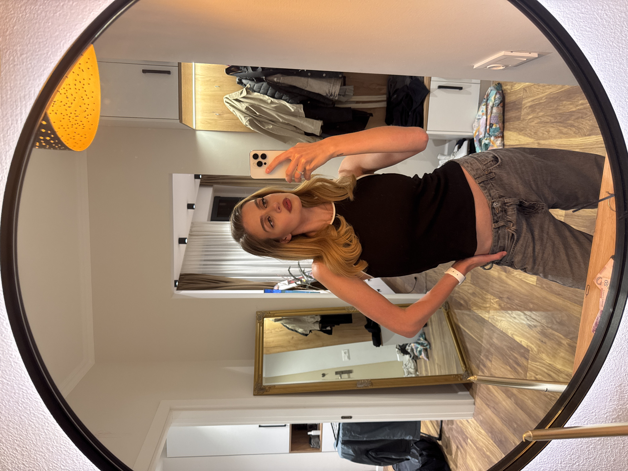 Woman takes mirror selfies during brief photo session