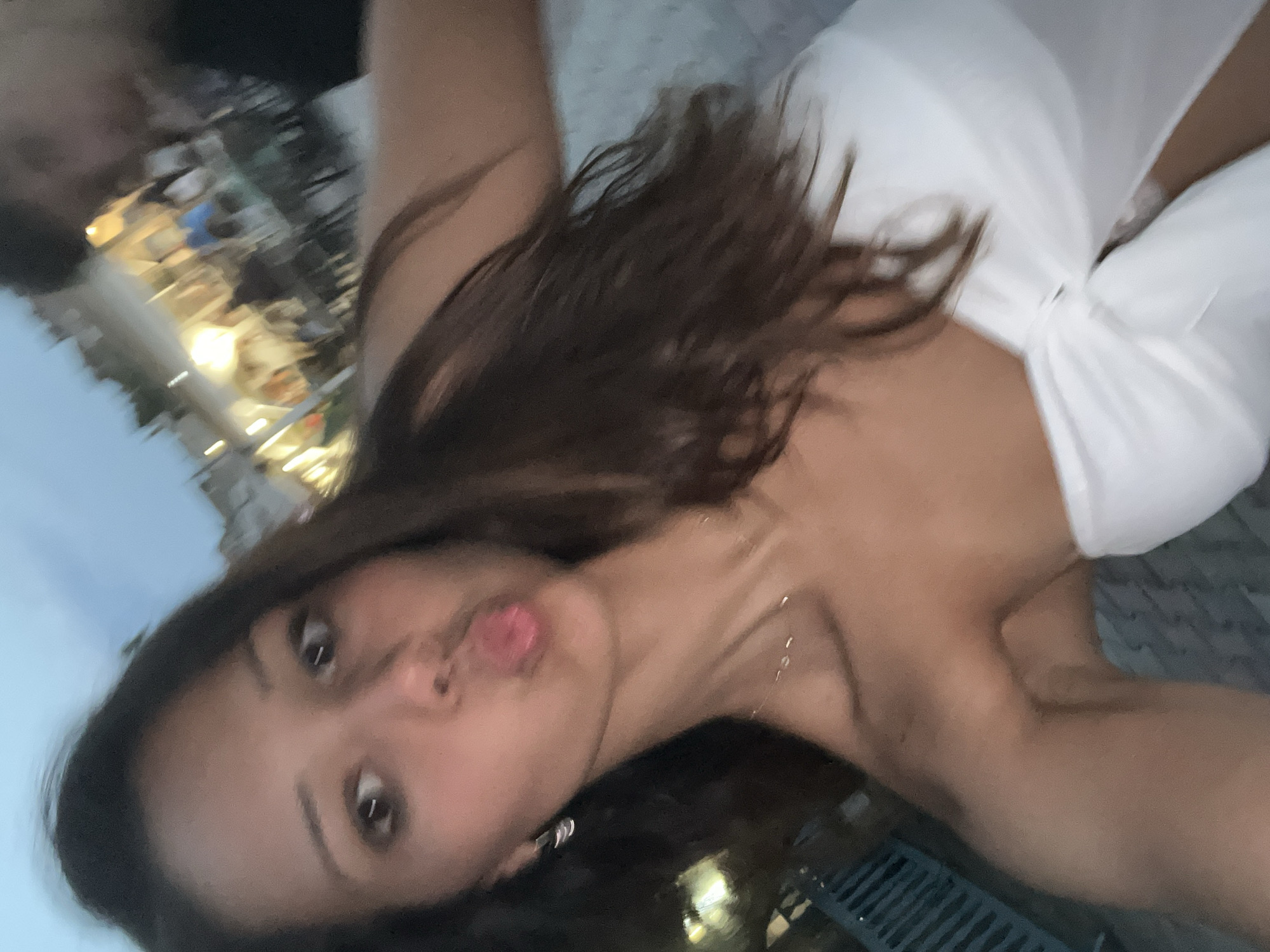 Dusk selfie on a Fanari street with outdoor dining behind