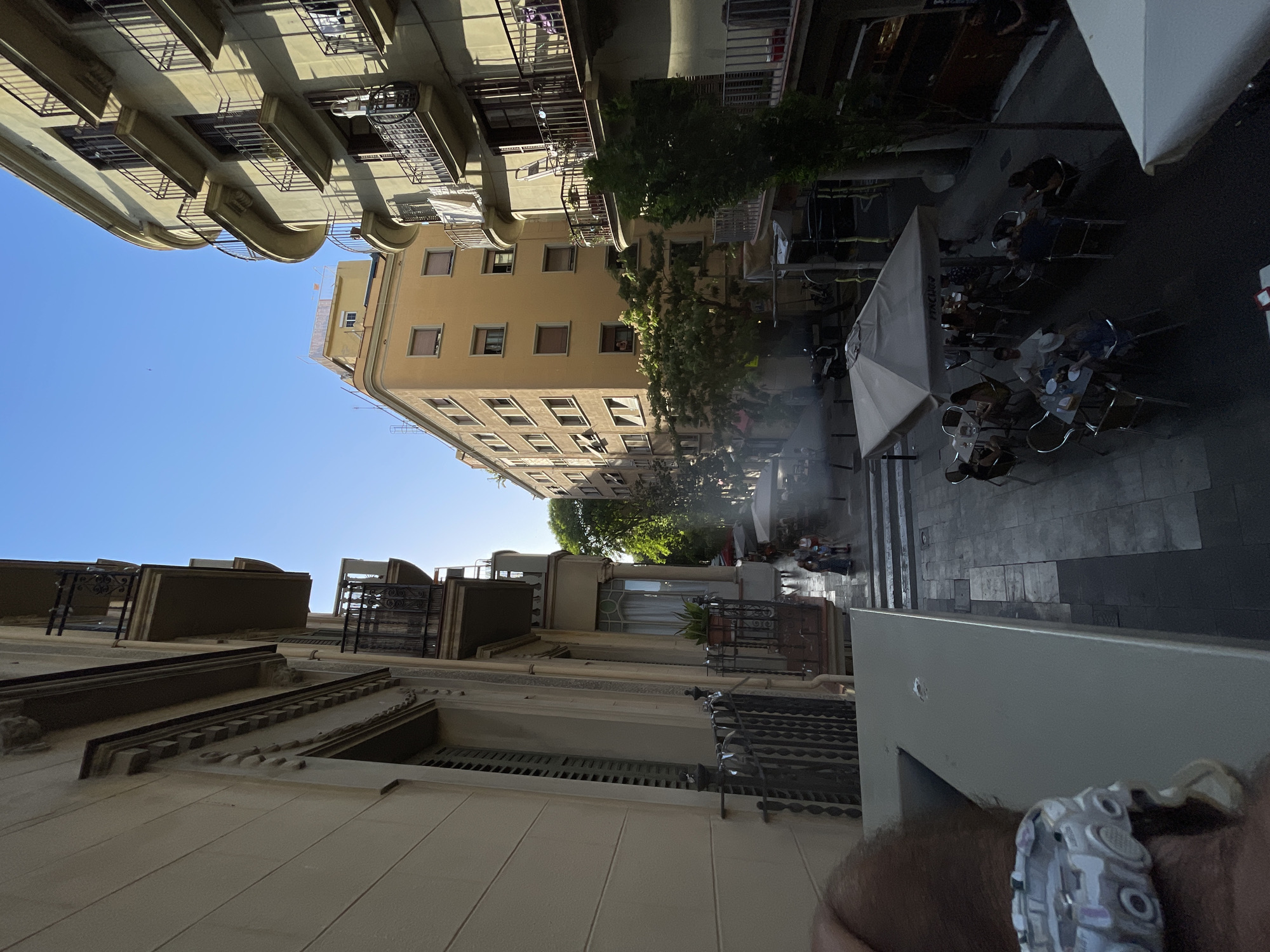 Barcelona balcony afternoon: narrow streets, cafes, clear skies