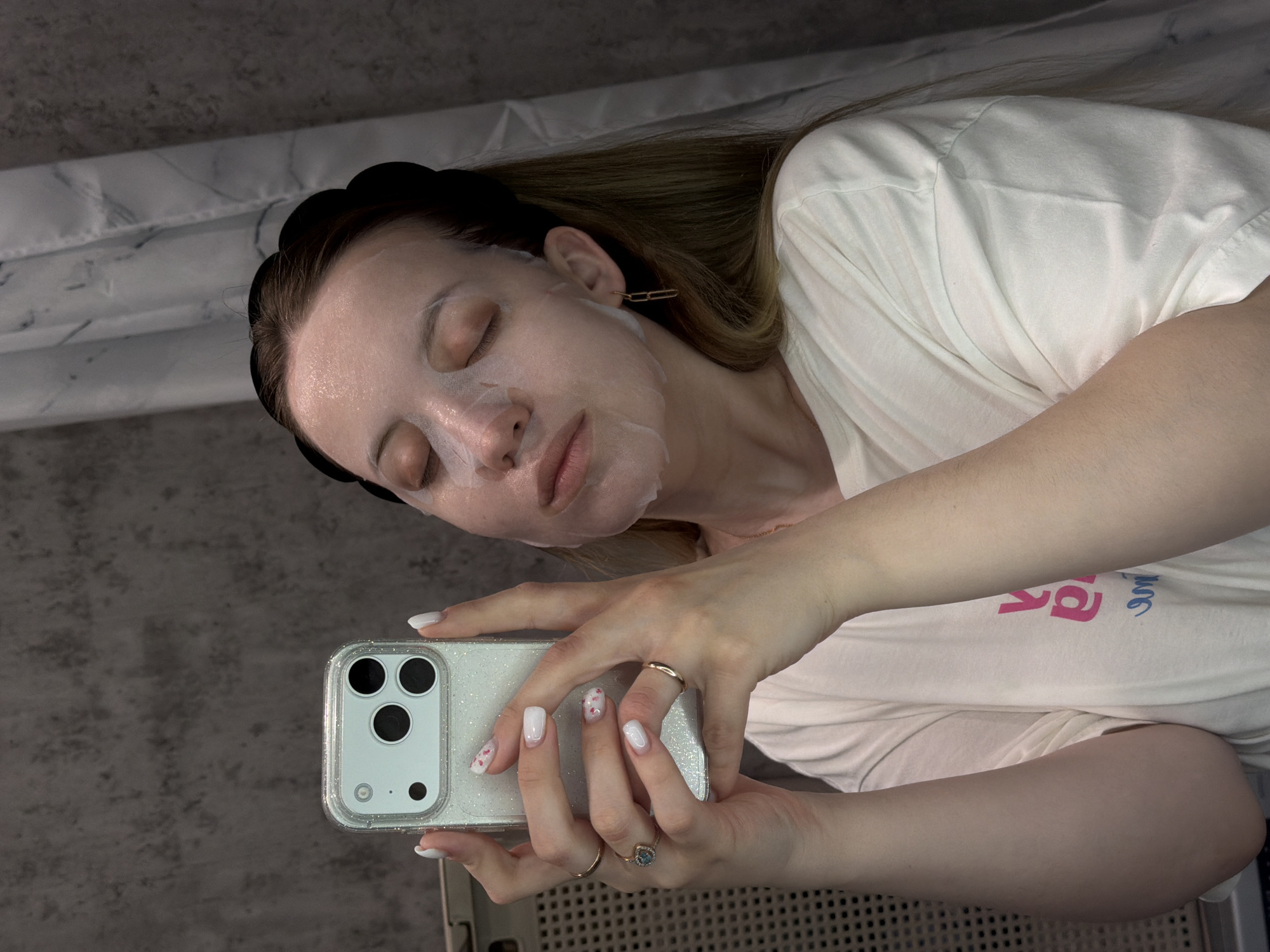 Woman documents morning self-care routine with face mask and breakfast