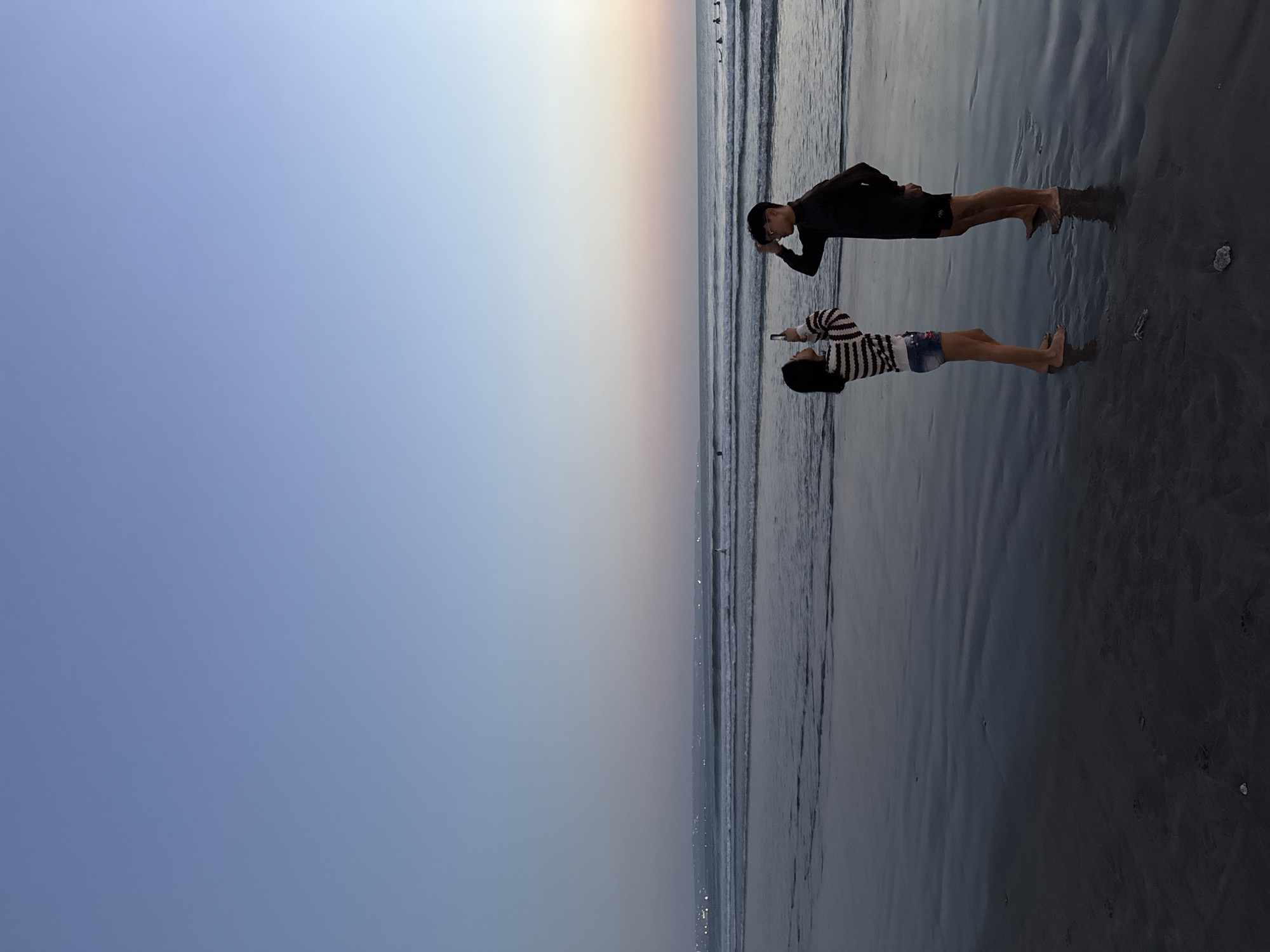 Kuta Beach at golden hour, busy and relaxed