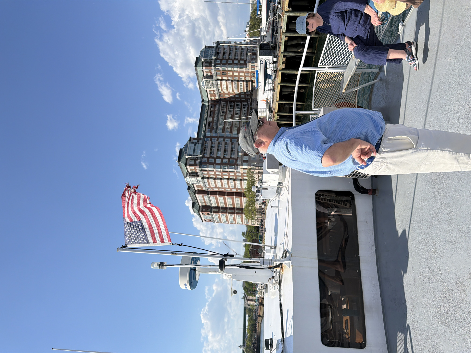 Boat with weathered flag observed in Boston harbor