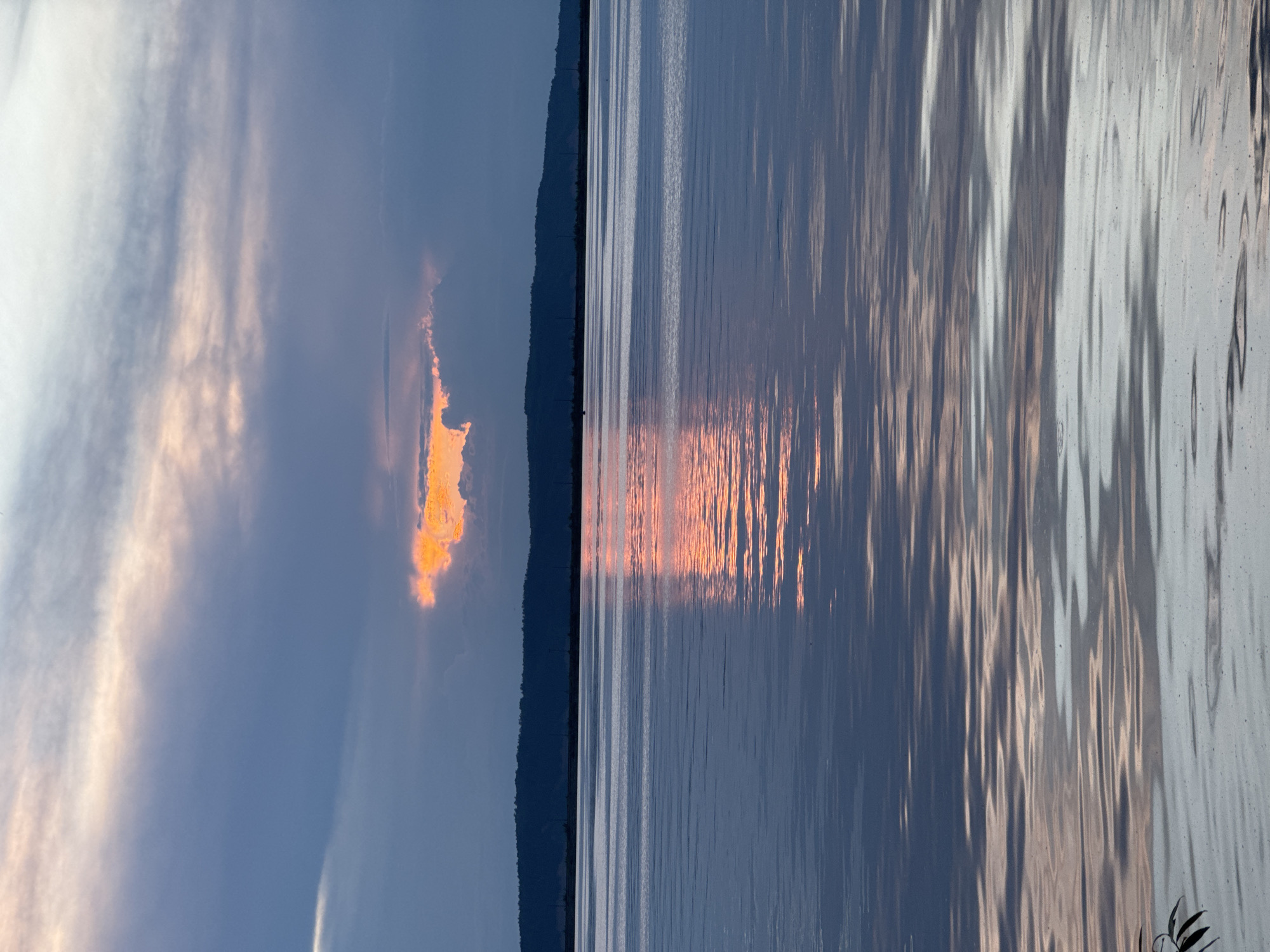 Dramatic sunset captured over serene water body